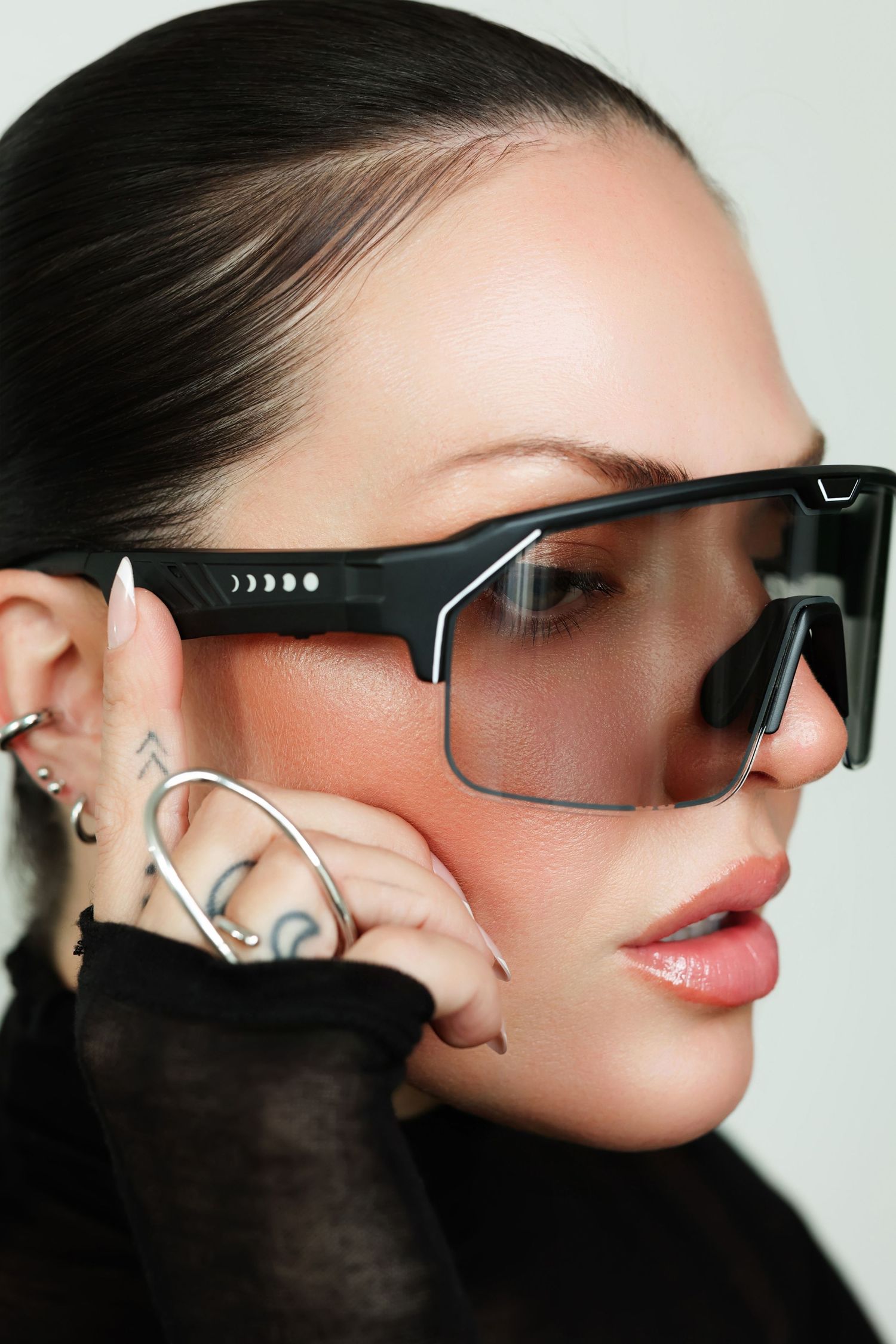 Close-up fashion shots showcasing modern sunglasses design with black frame details.