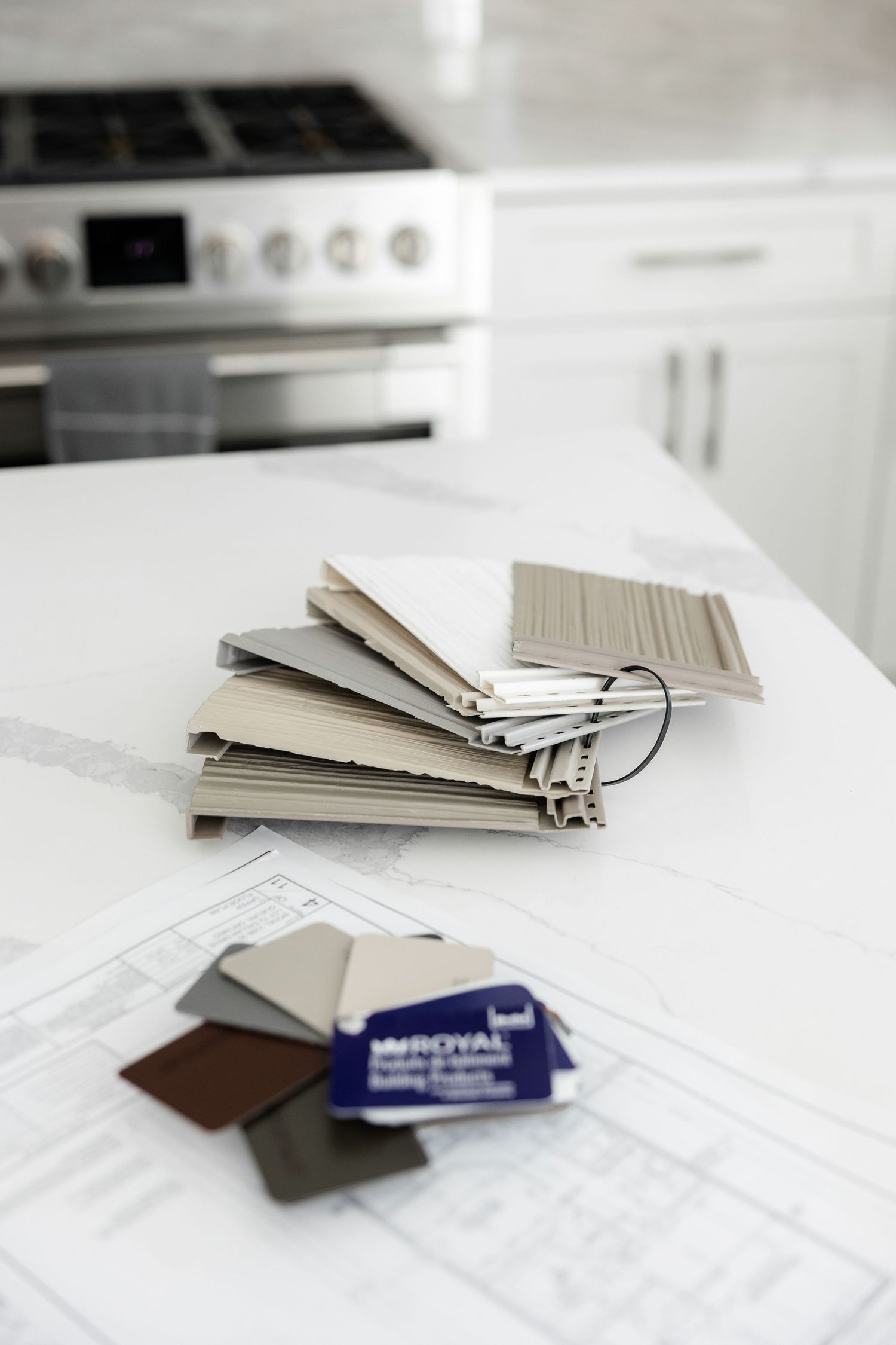 Material samples and swatches displayed on white marble countertop.