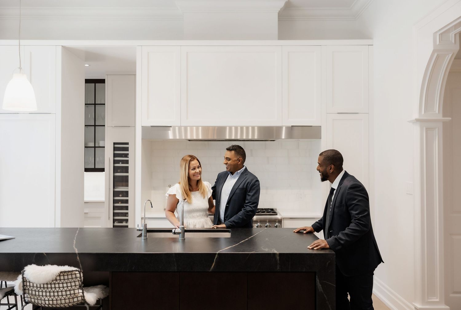 Modern white kitchen interior with sleek cabinets and minimal design.