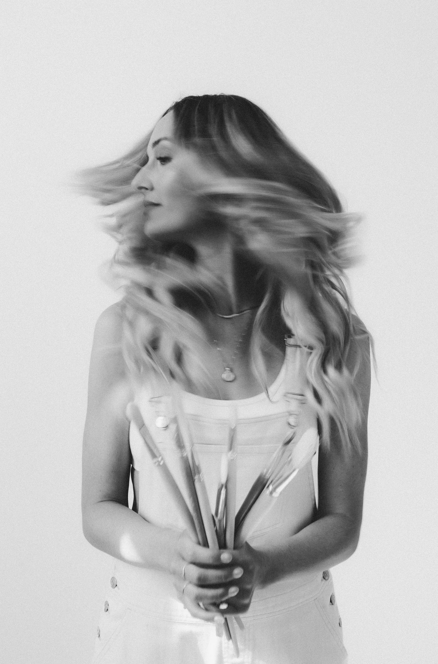 Black and white motion portrait series capturing flowing blonde hair movement.