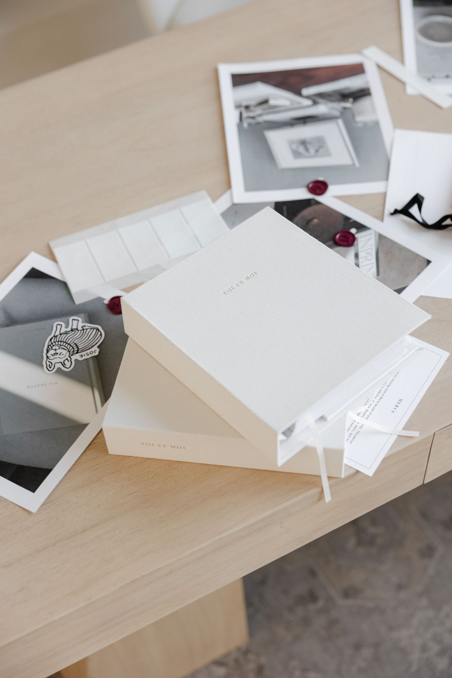 Collection of white papers and documents with red wax seals scattered on wooden desk.