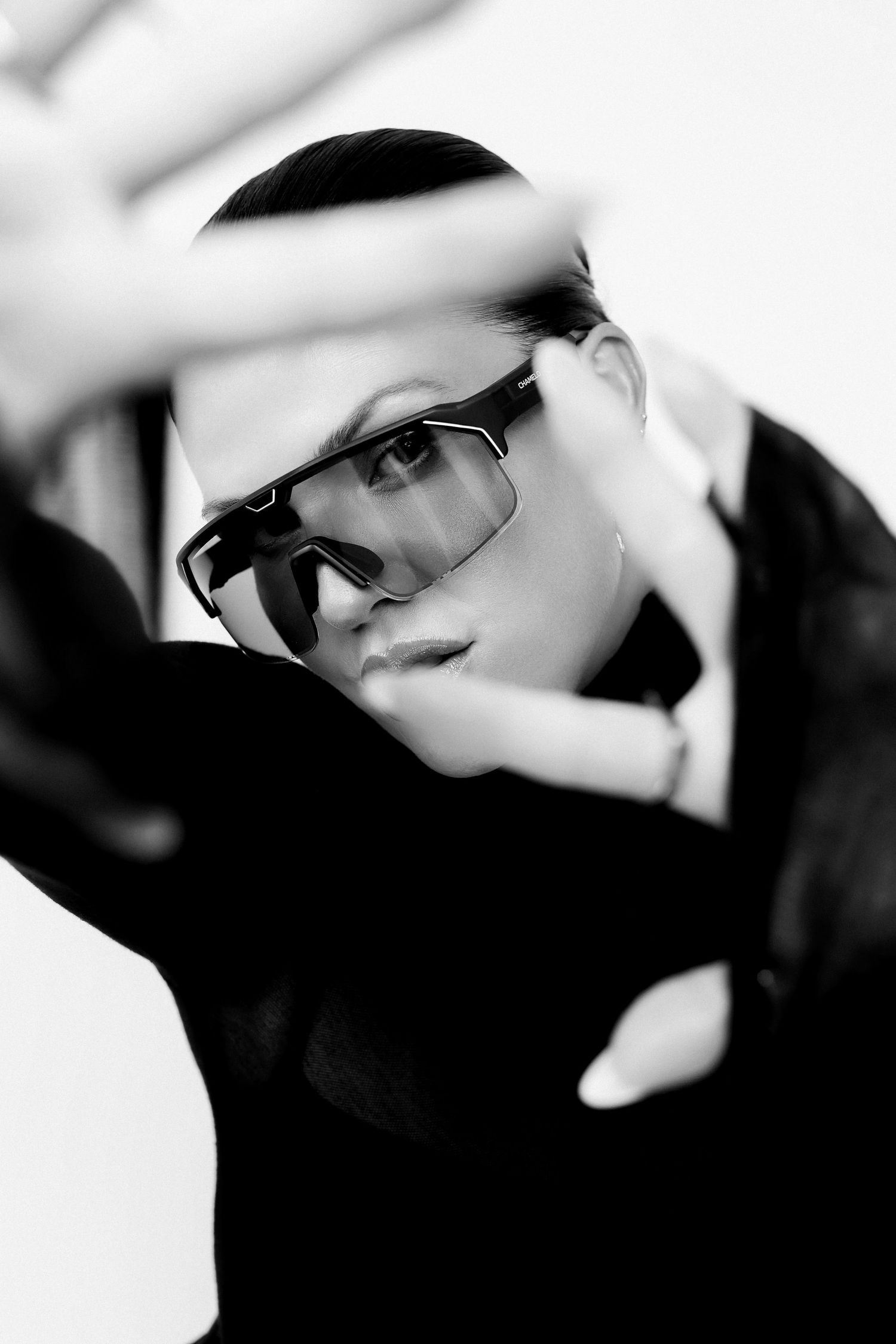 Artistic black and white fashion portraits with dramatic lighting and eyewear focus.