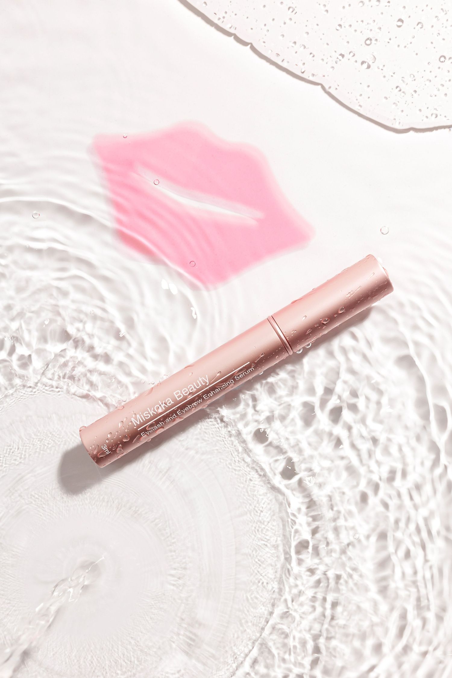 Pink metallic cosmetic pen against white background with pink lip gloss swatch.