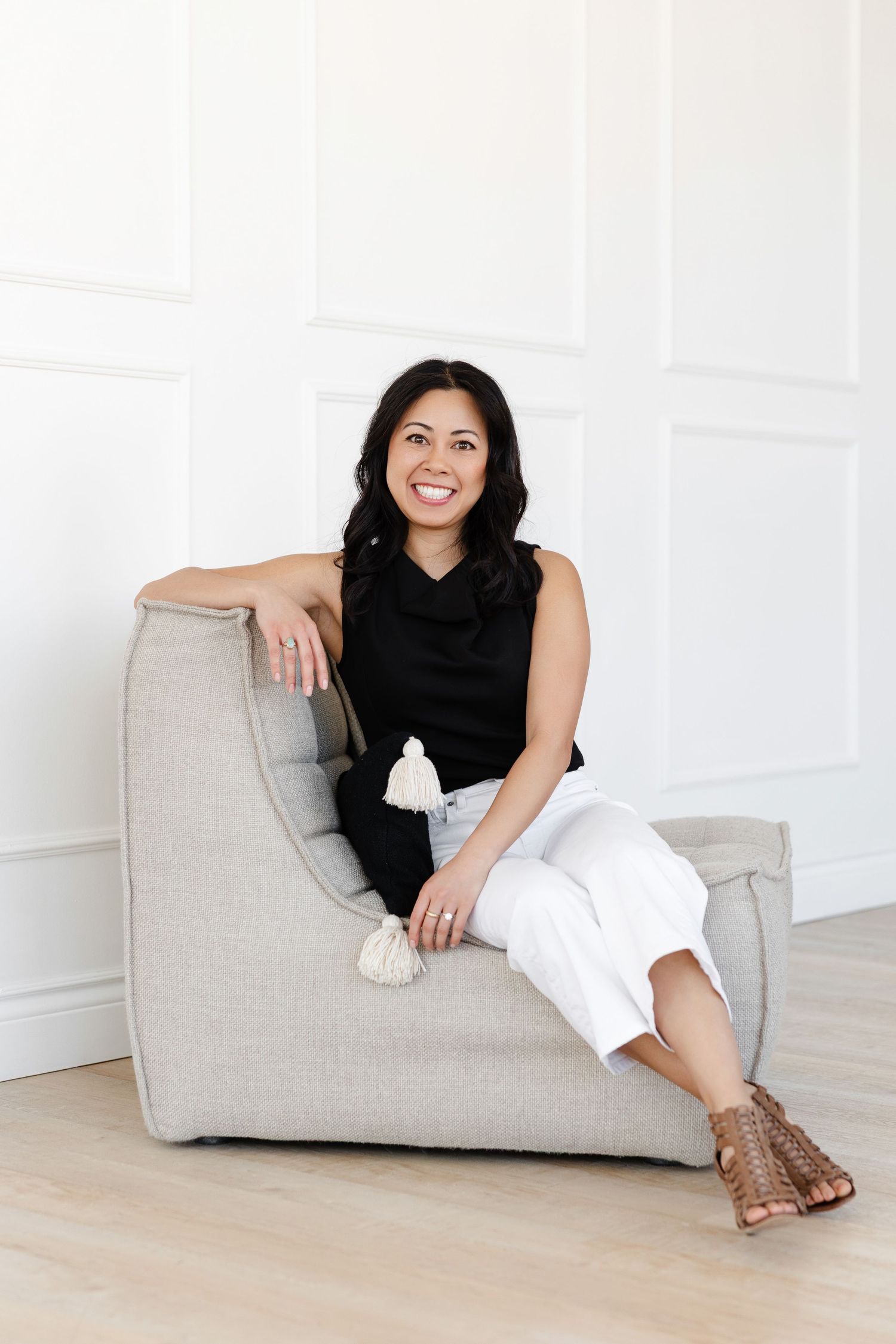 Casual lifestyle poses on a gray modern lounger against white wall.