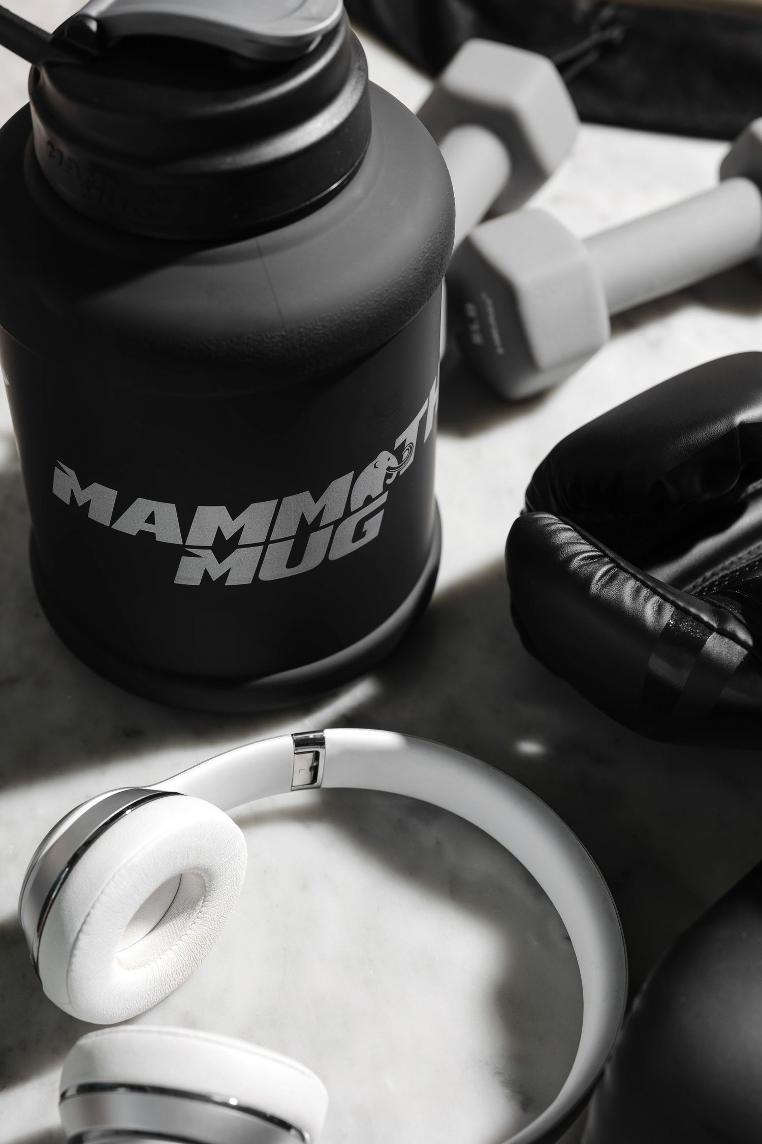 Collection of black and white sports bottles arranged in artistic composition.