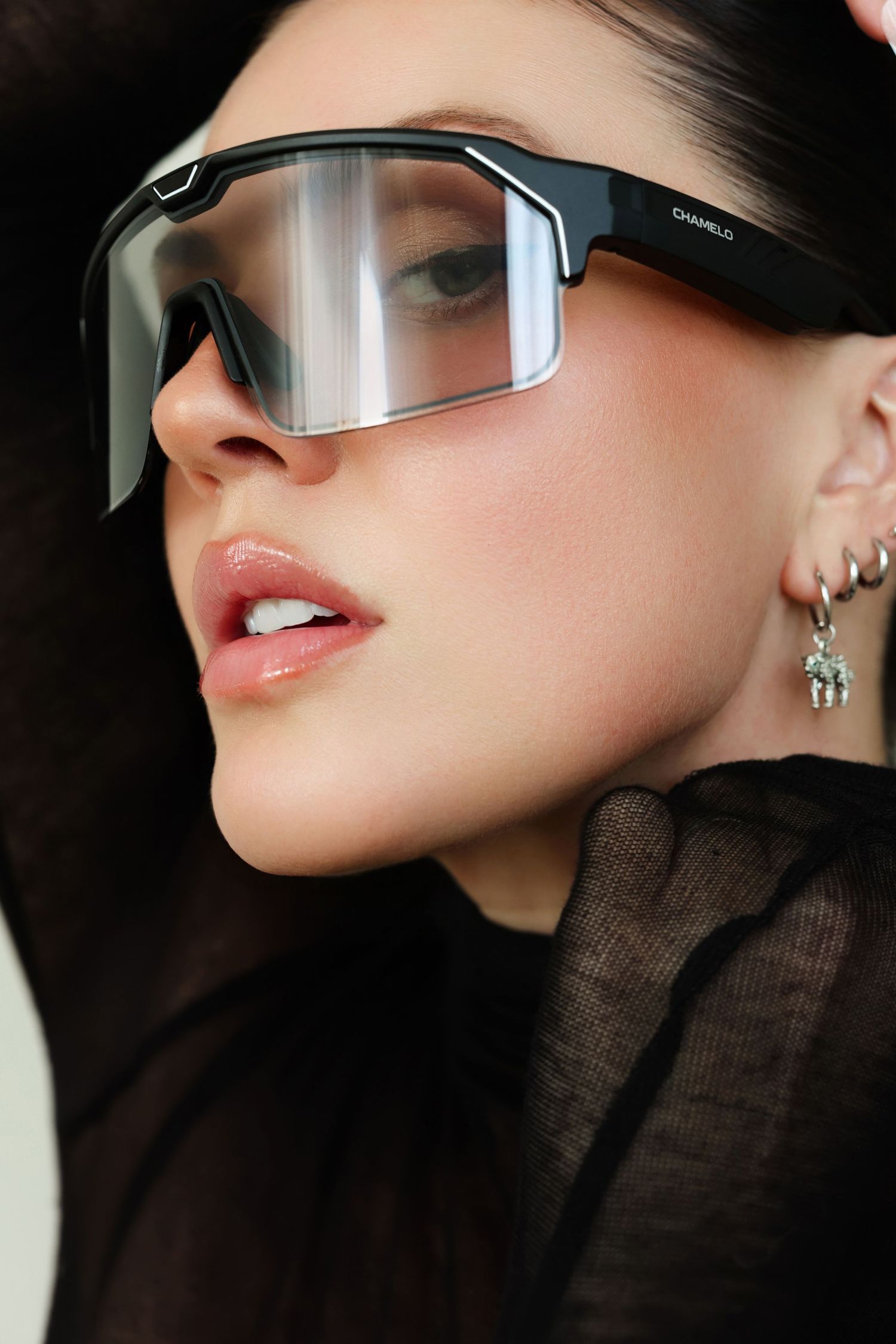 High fashion sunglasses editorial with dramatic angles and black turtleneck styling.