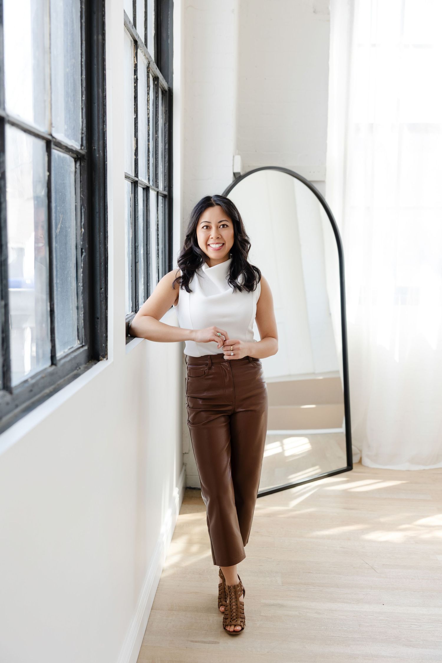 Modern bright studio space with natural light streaming through industrial windows.