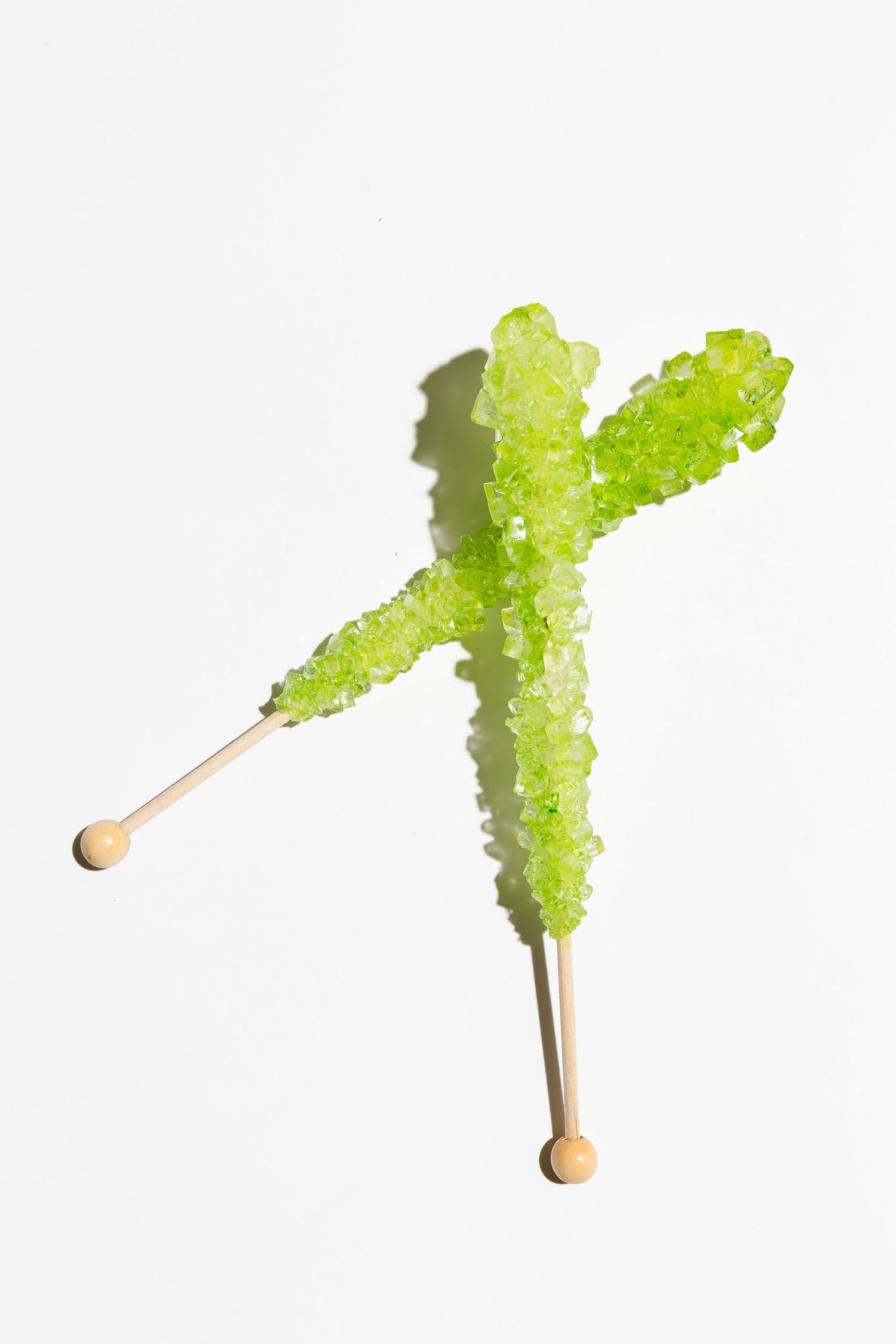 Time-lapse sequence showing green crystal formation on a candy stick.