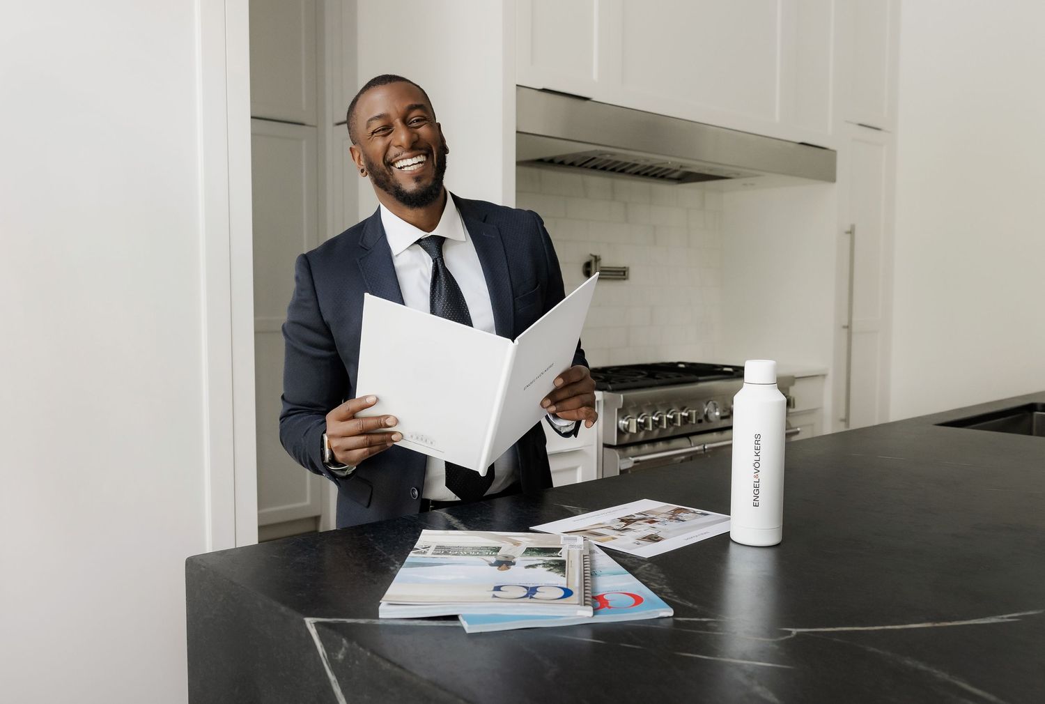 Professional reviewing business documents at a modern black conference table.