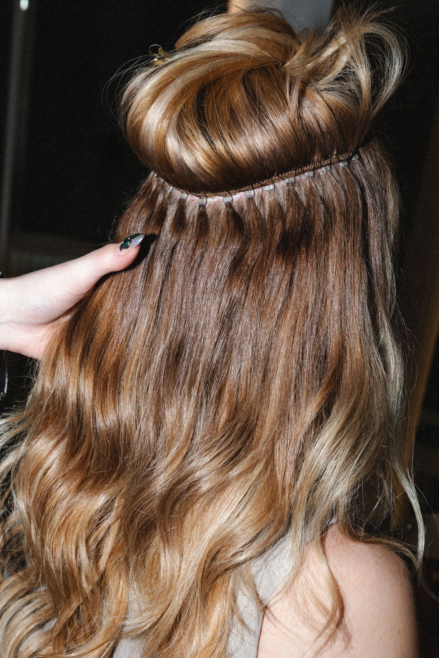 Close-up shots of wavy honey blonde hair styling sequence.