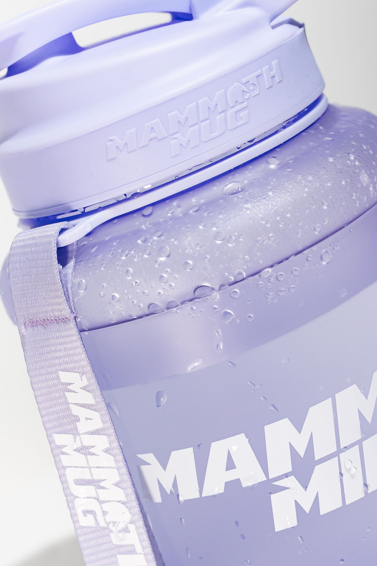 Purple Mammoth Mini shaker bottle with water droplets on surface against white background.