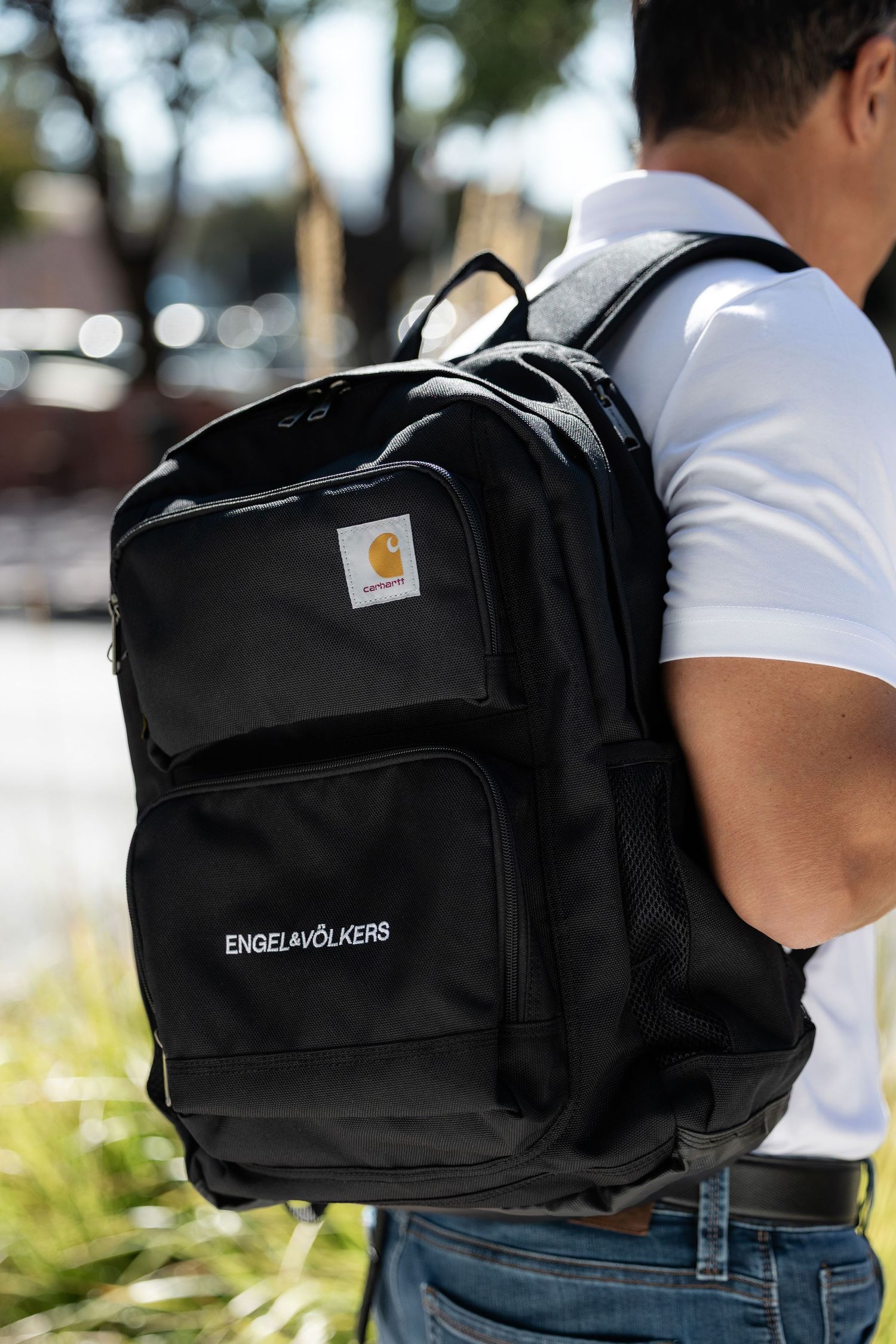 Black backpack with Engel&Volkers branding shown from multiple angles.
