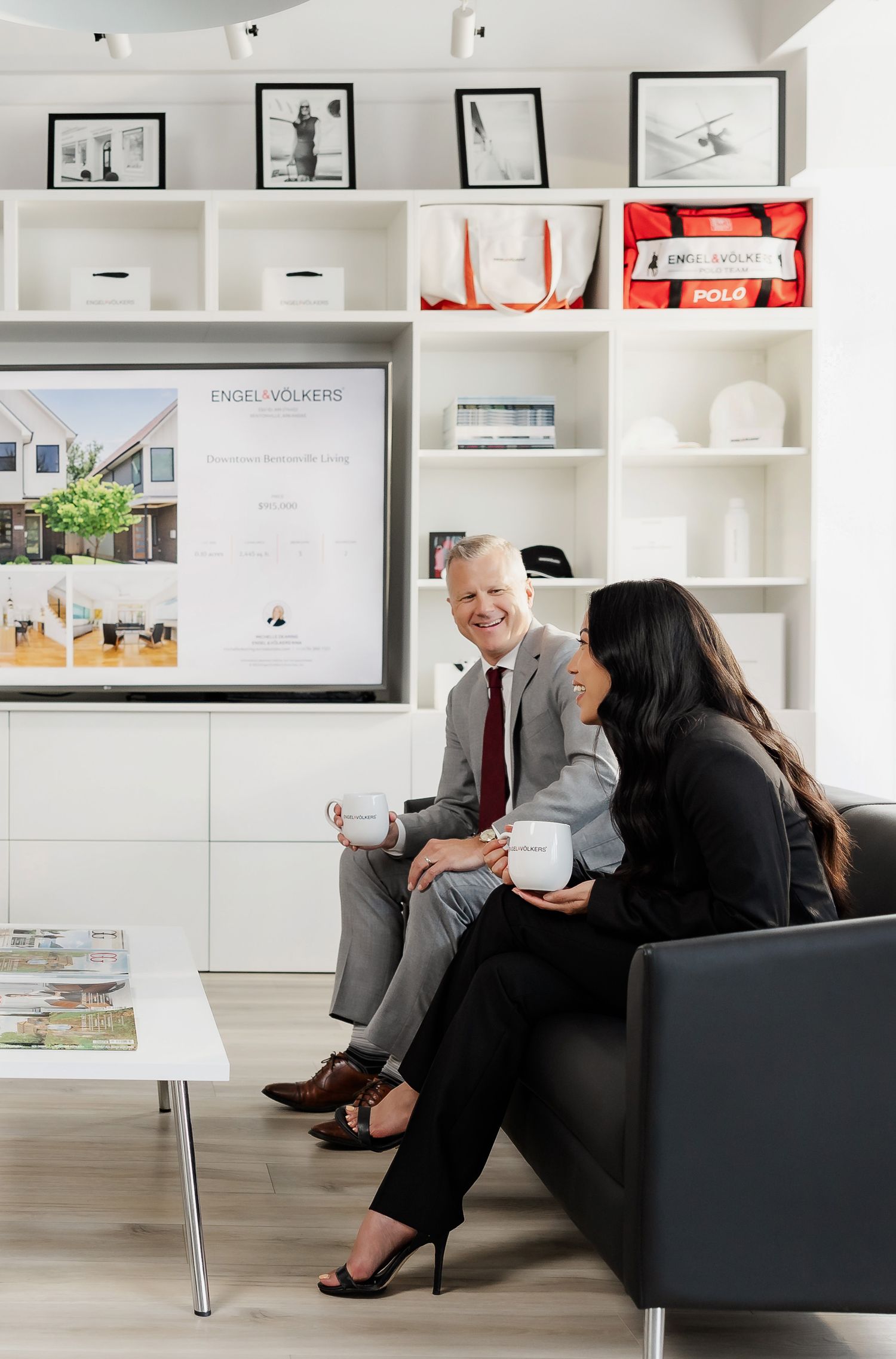 Professional office meeting in bright white space with built-in shelving and artwork.