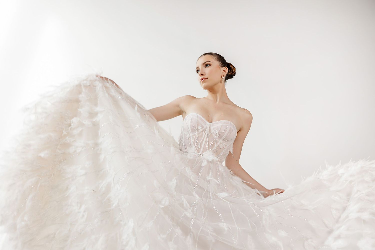 Ethereal white wedding gown with flowing fabric captured in dynamic motion shots.