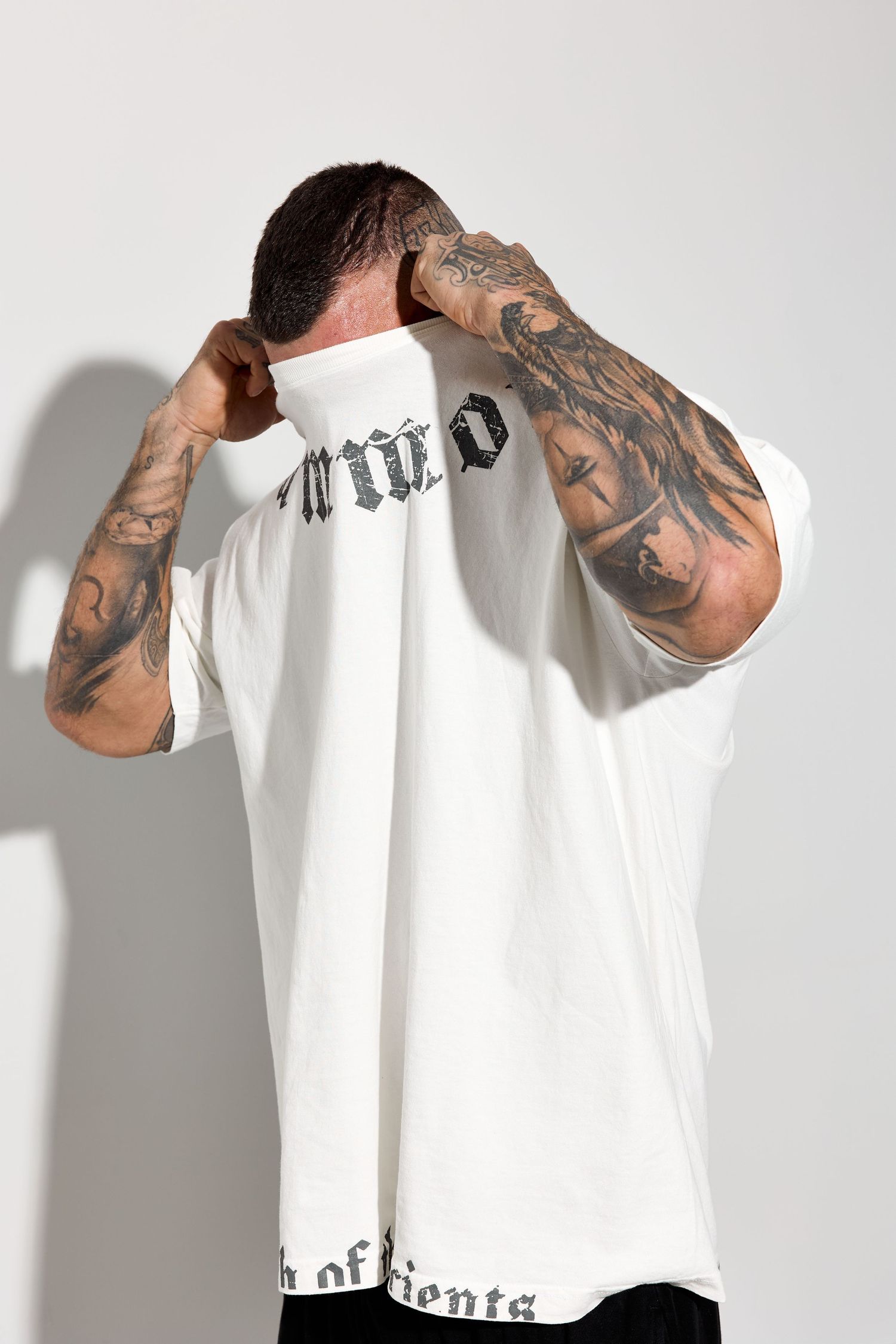 White t-shirt with gothic text design modeled from different angles.