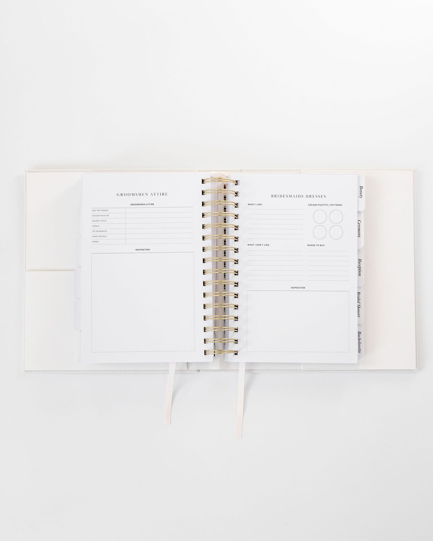 Open spiral notebook with blank planning pages on white surface.