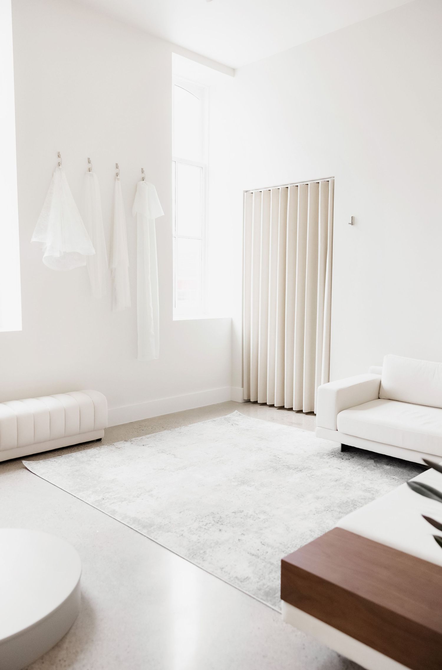 Bright white interior space with vertical wooden slats and modern furniture.