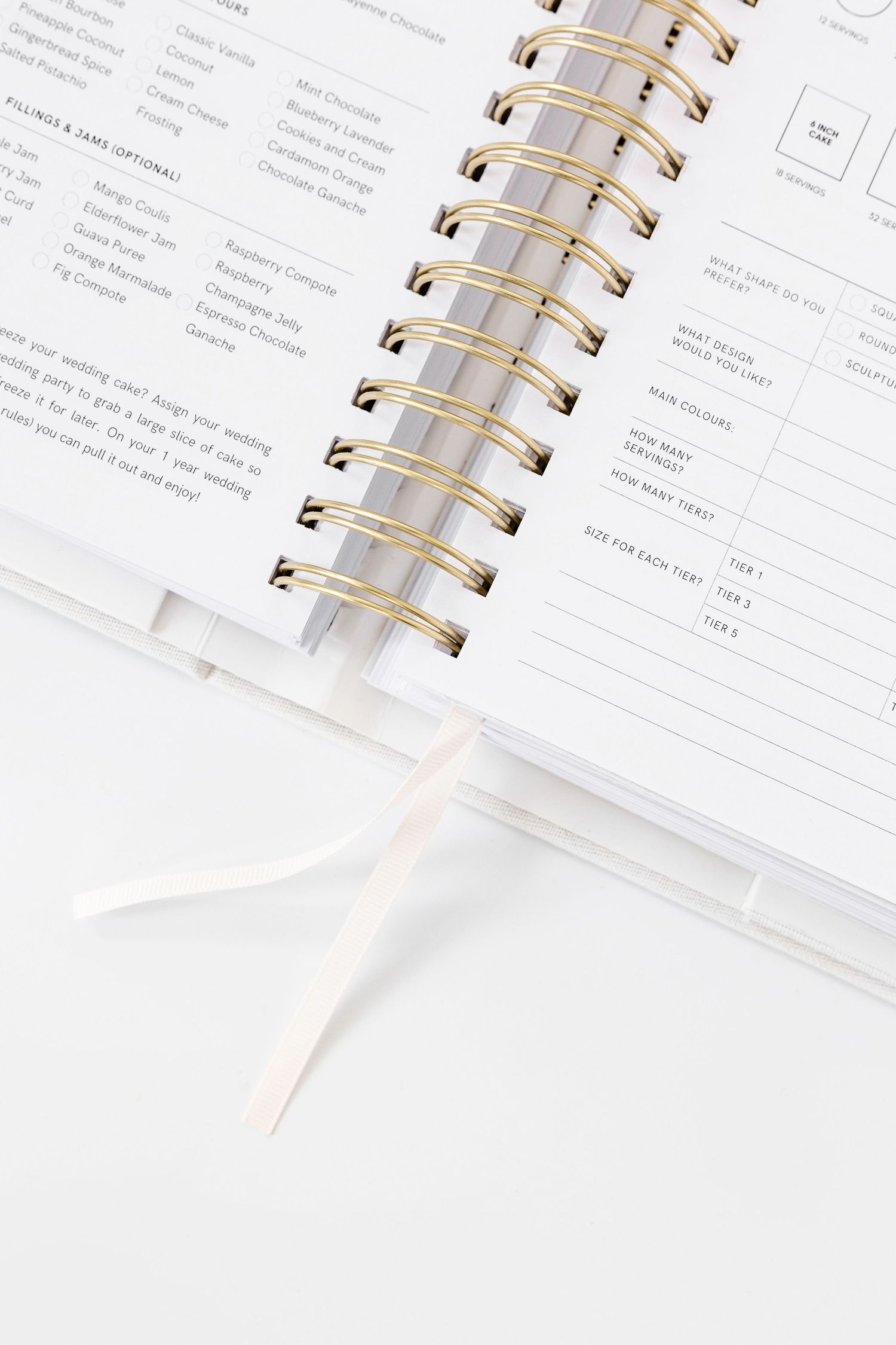 Detailed wedding planning checklist pages shown in spiral-bound white planner.