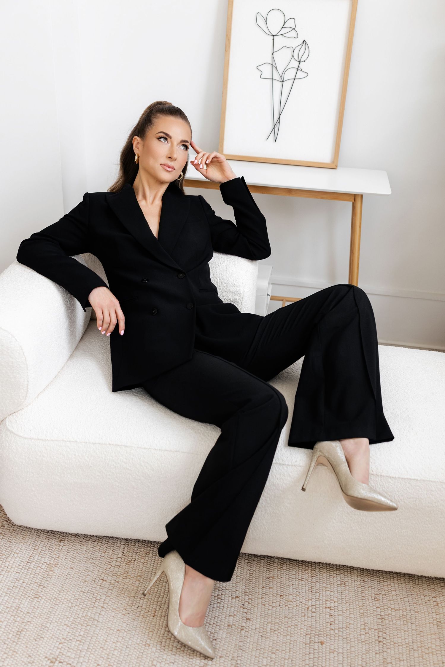 Professional fashion photo series showing a black blazer outfit styled with beige heels against a minimal white backdrop.