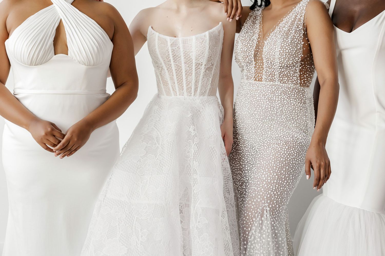 Close-up details of various white wedding dress bodices showing different necklines and textures.