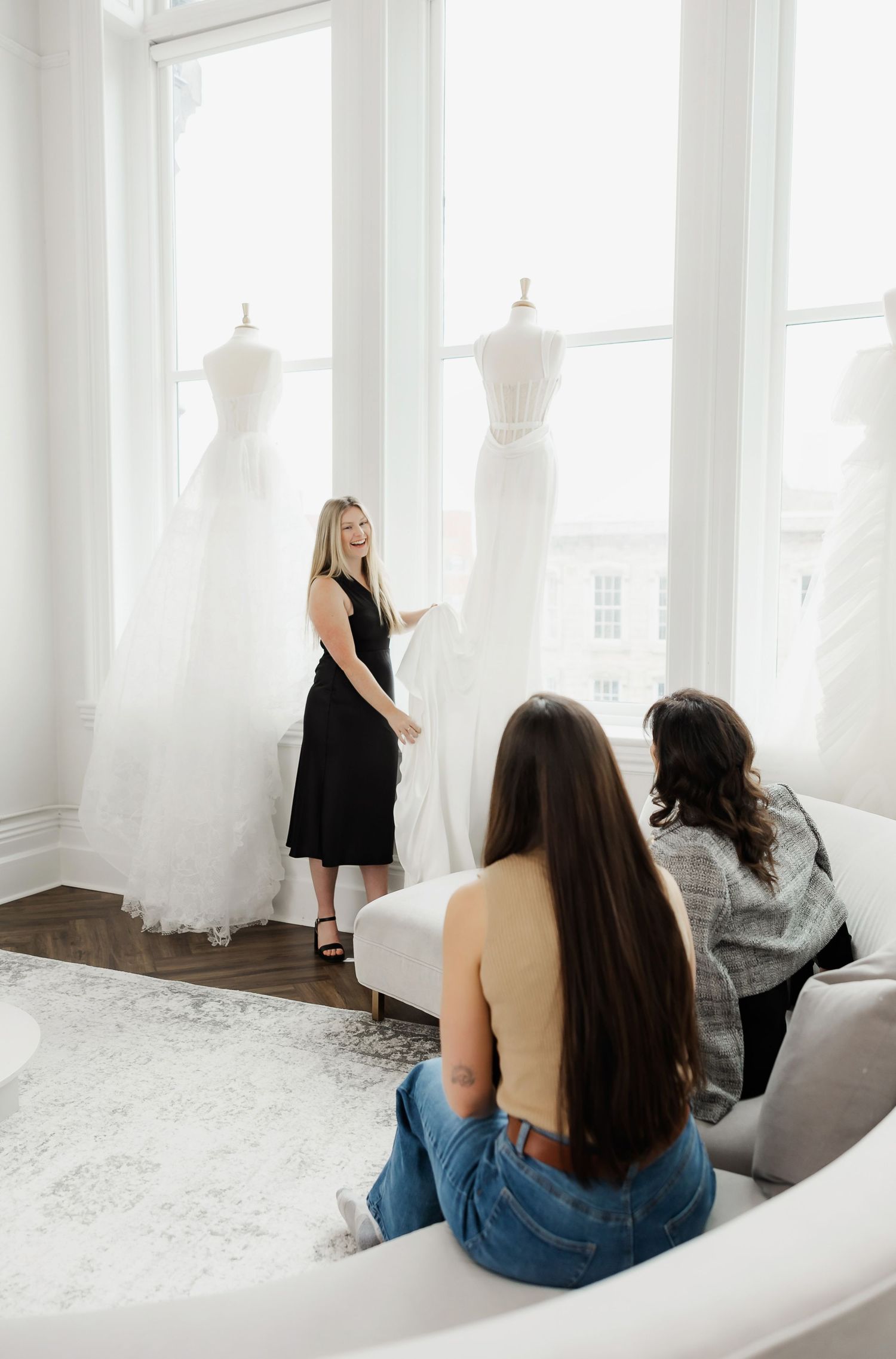 Relaxed bridal appointment in an elegant white showroom with large windows.