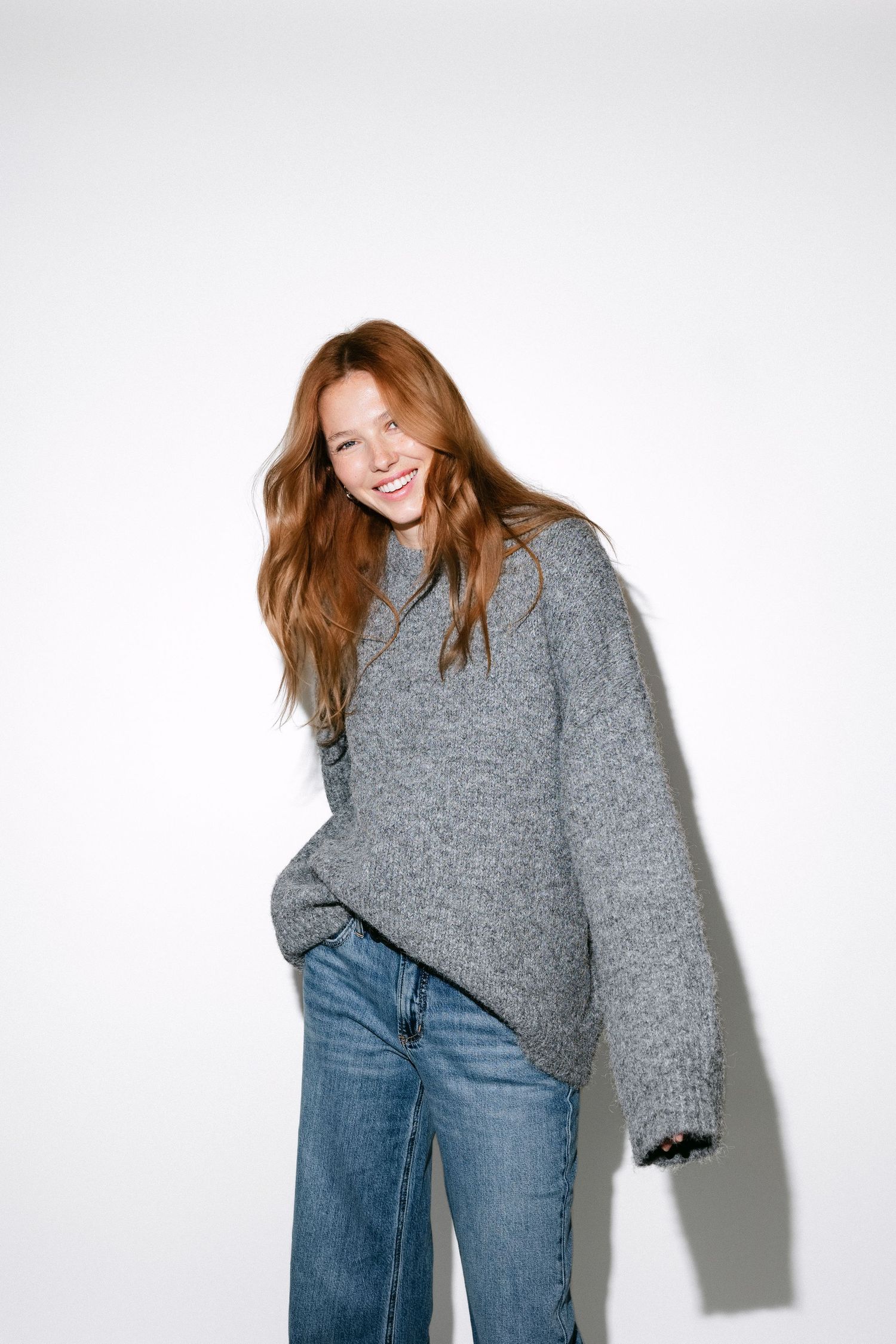 Casual style photo featuring oversized grey knit sweater with classic blue denim.