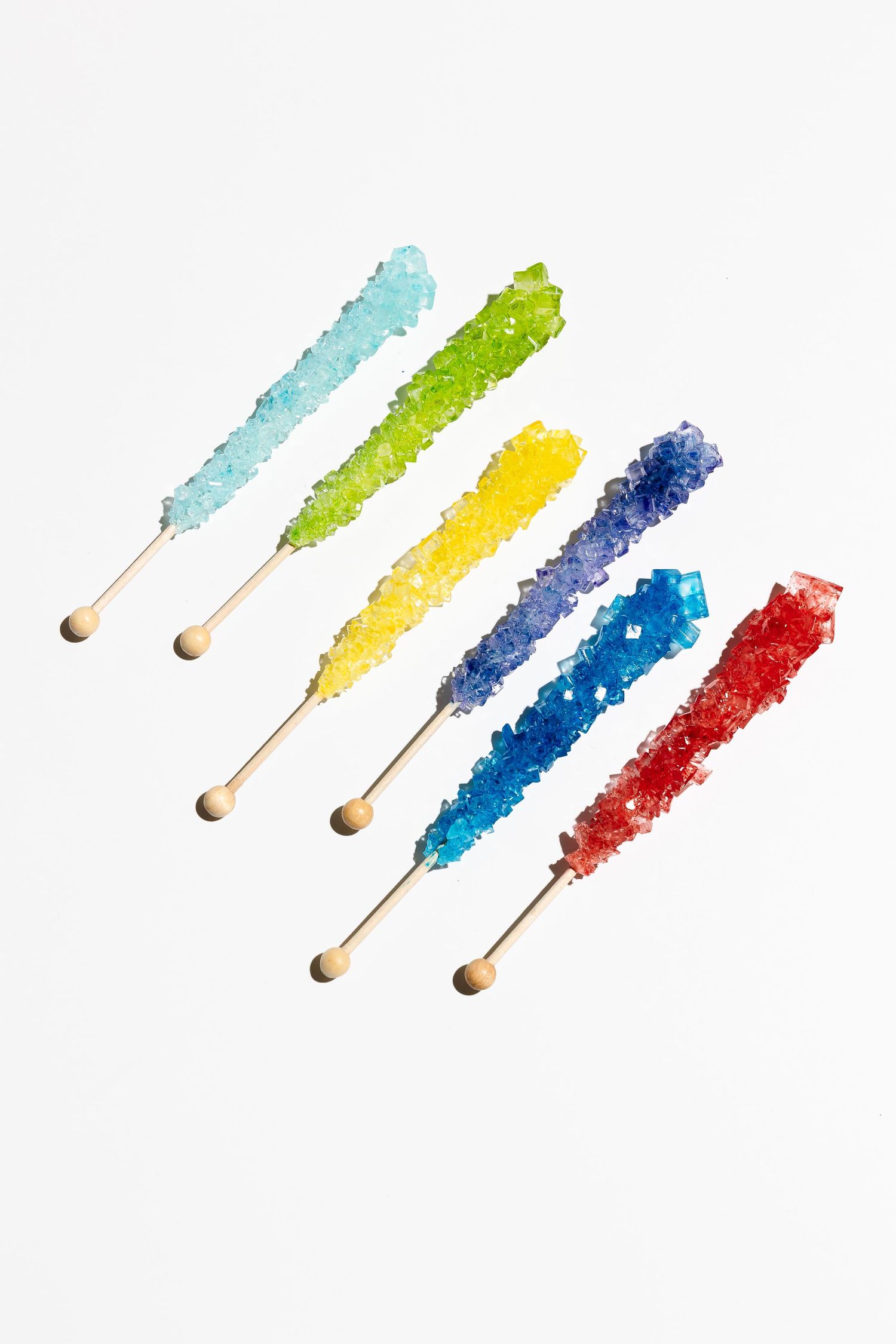 Progressive sequence showing colorful rock candy sticks arranged in ascending order.
