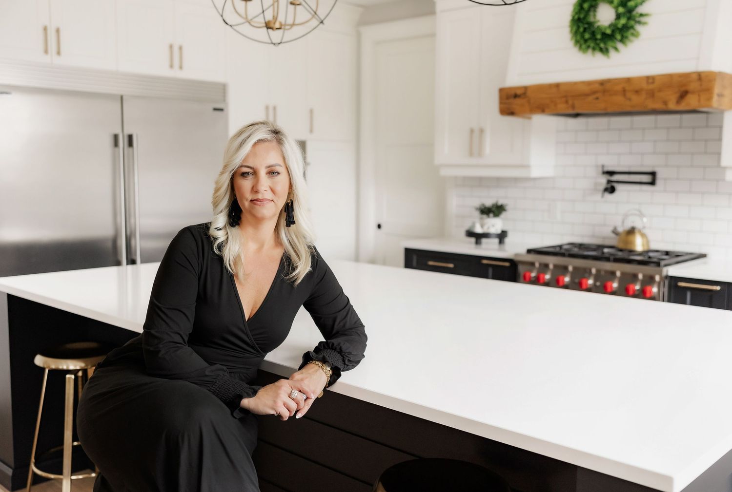 Modern kitchen interior with white countertops and black accents.