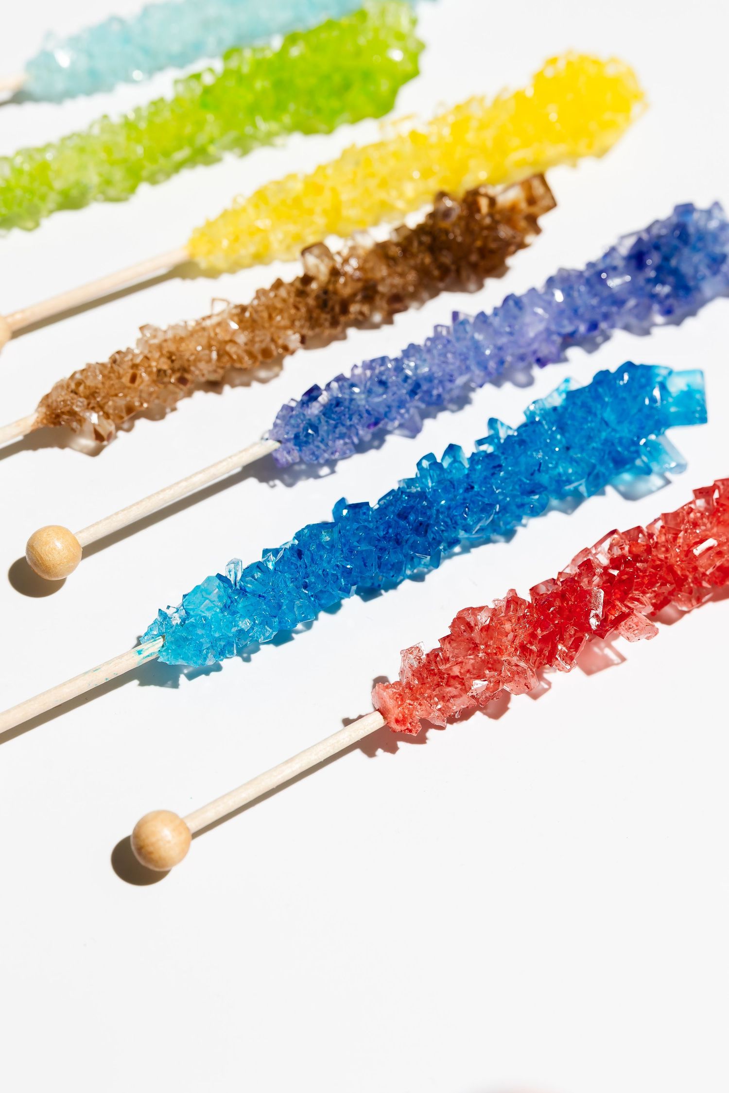 Multicolored rock candy sticks displaying various bright crystalline formations.