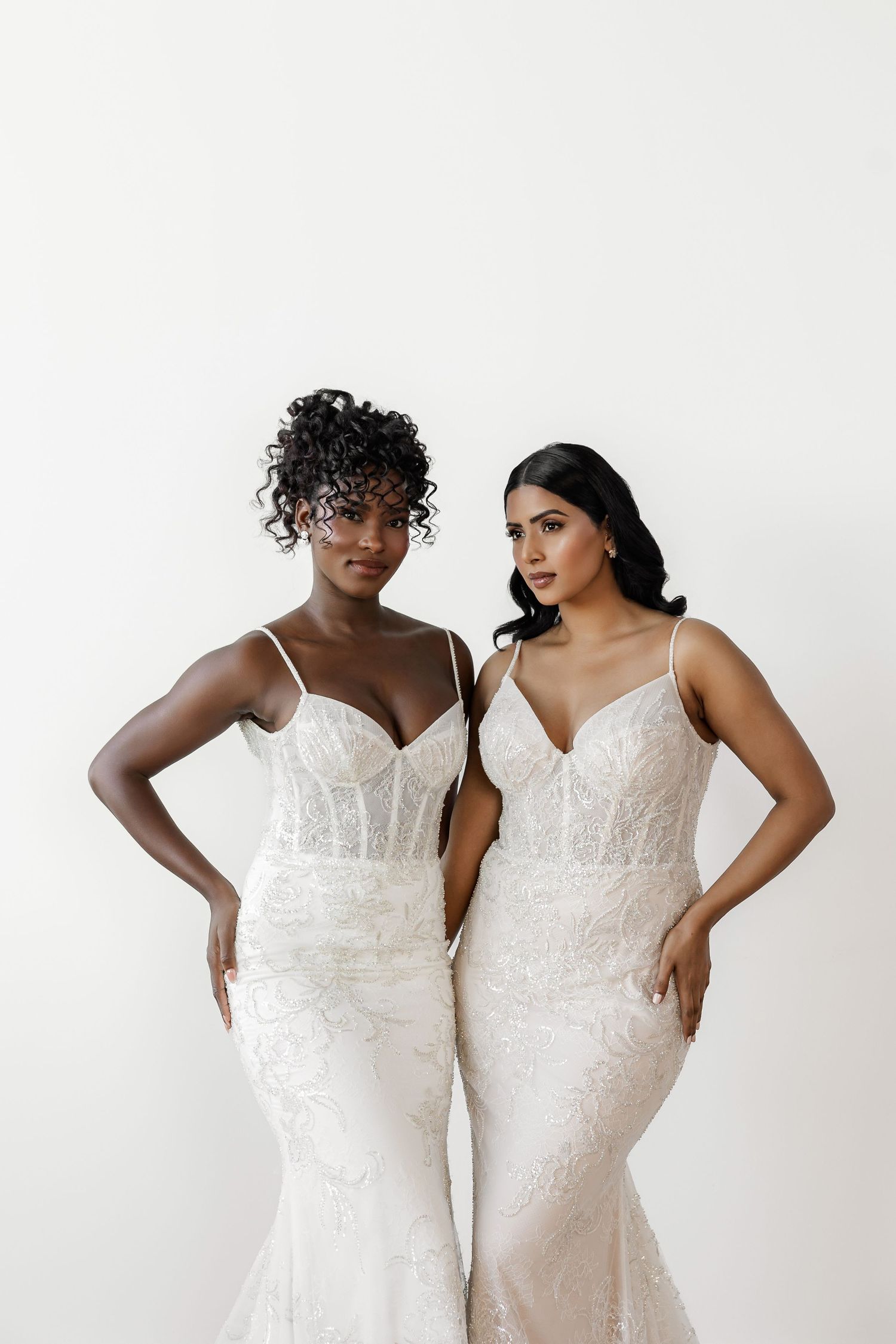 Wedding dress photoshoot featuring elegant white gowns with detailed lace and beadwork.