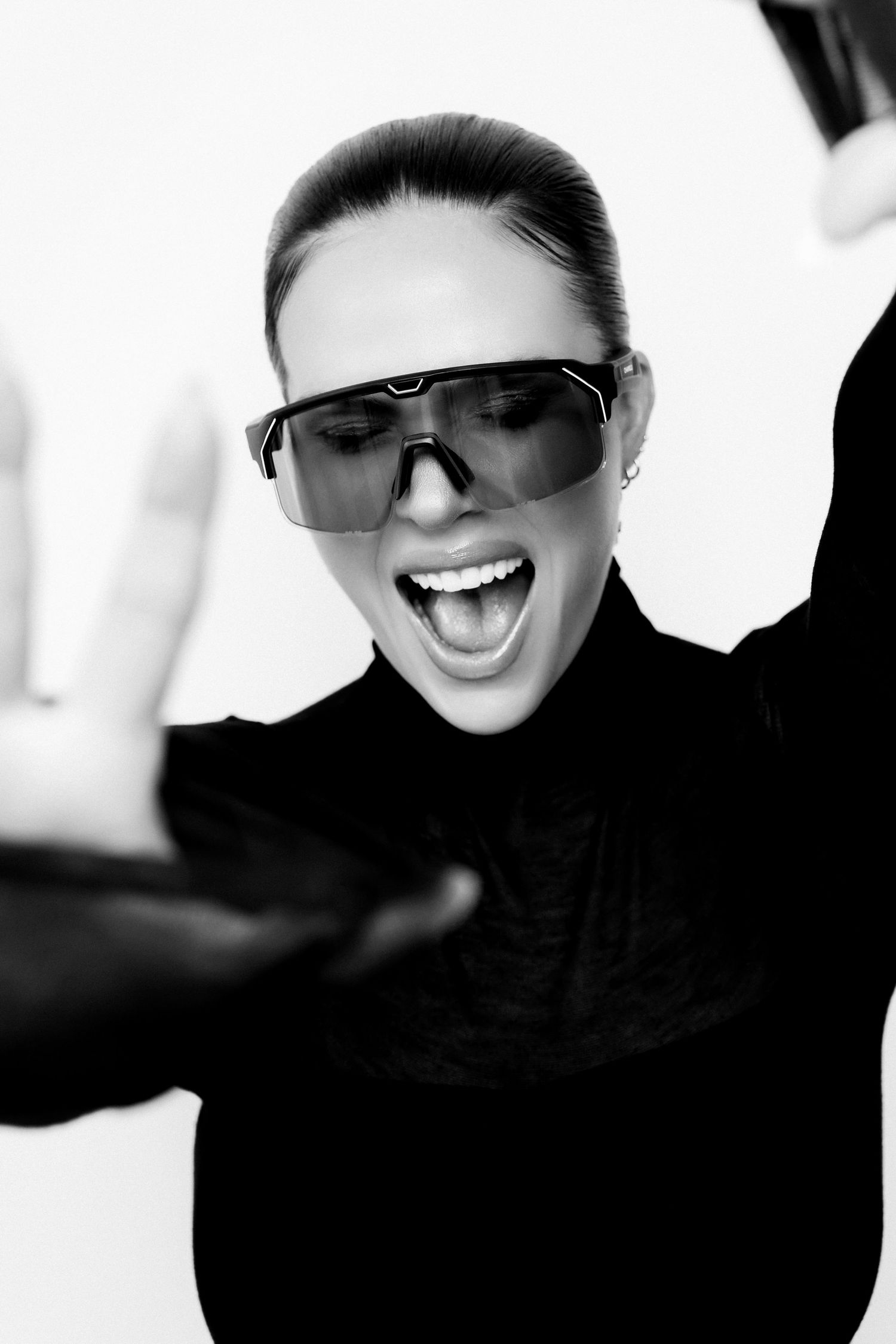 Black and white fashion portrait series featuring modern sunglasses and expressive poses.