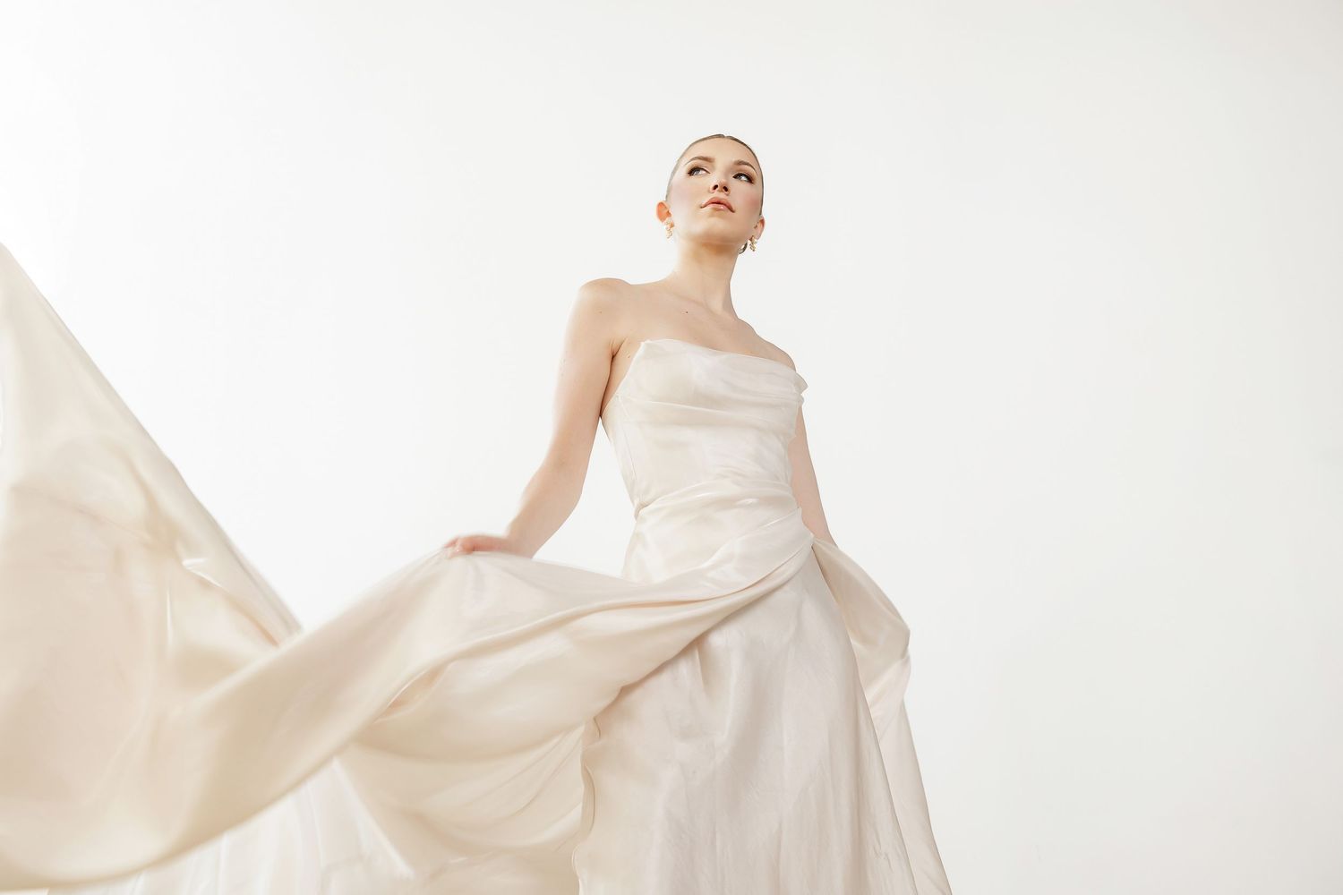 Romantic wedding dress with billowing fabric shown in dynamic movement sequence.
