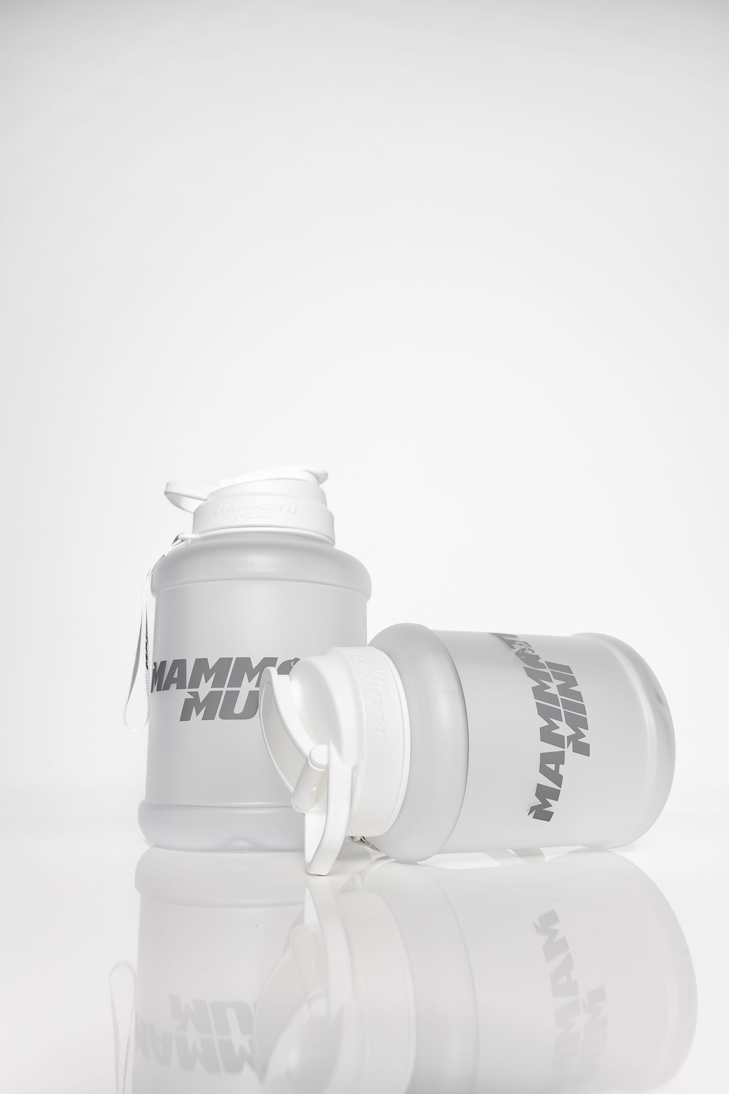Clear plastic drink containers with white lids arranged in a minimalist style.