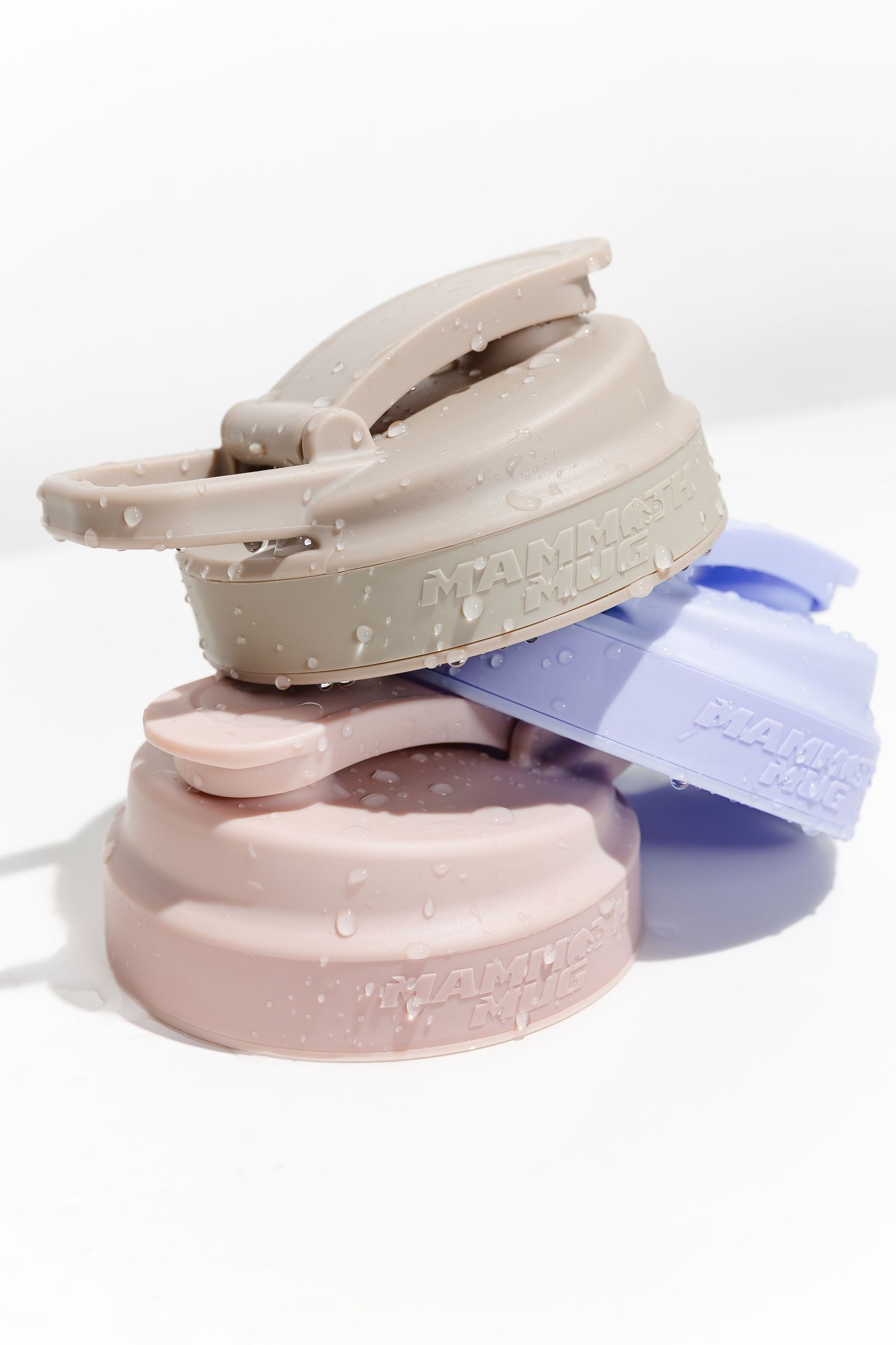Pastel colored drink container lids arranged in an artistic composition.