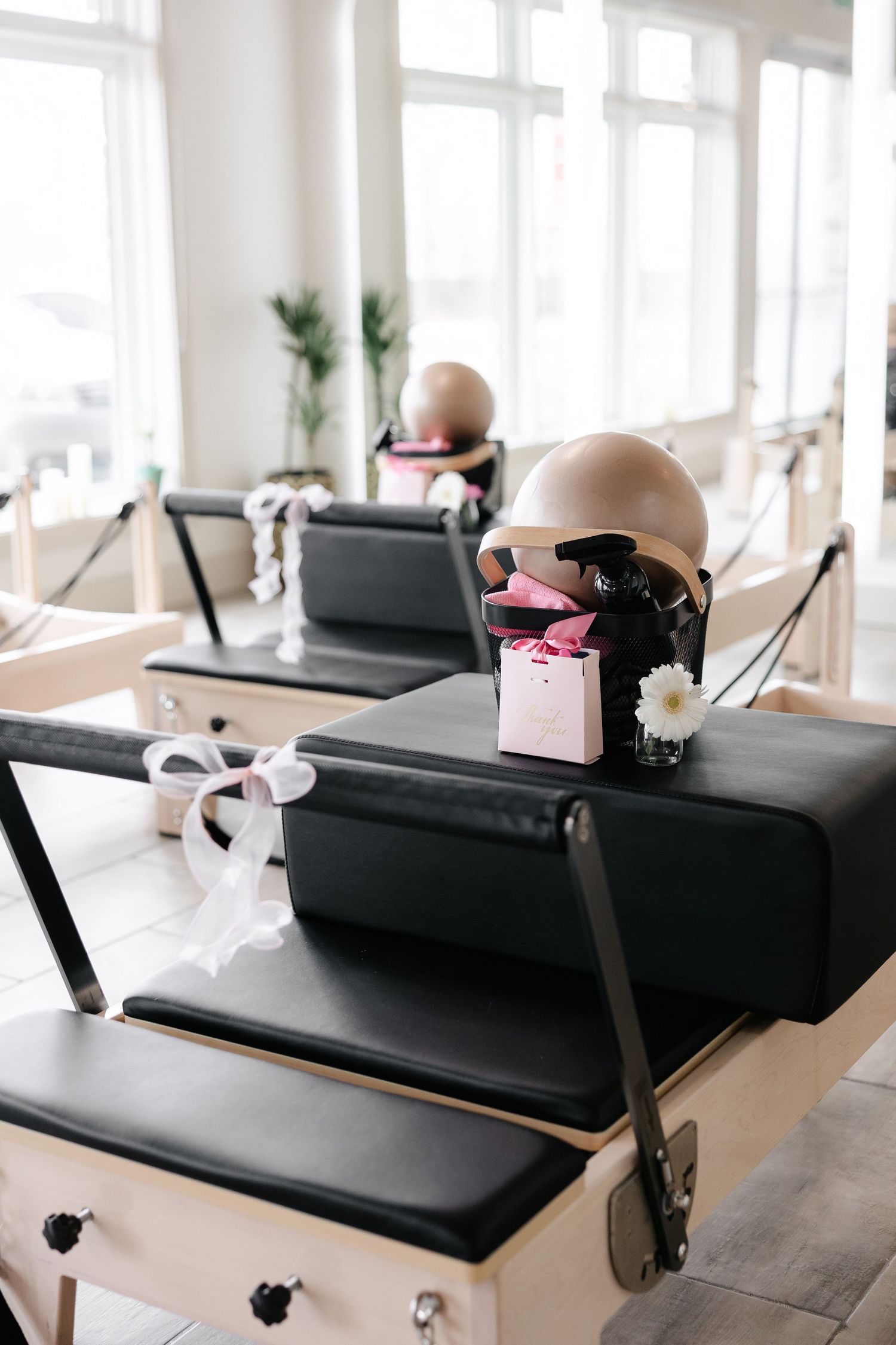 Sleek black pilates reformer equipment in bright studio with natural lighting.