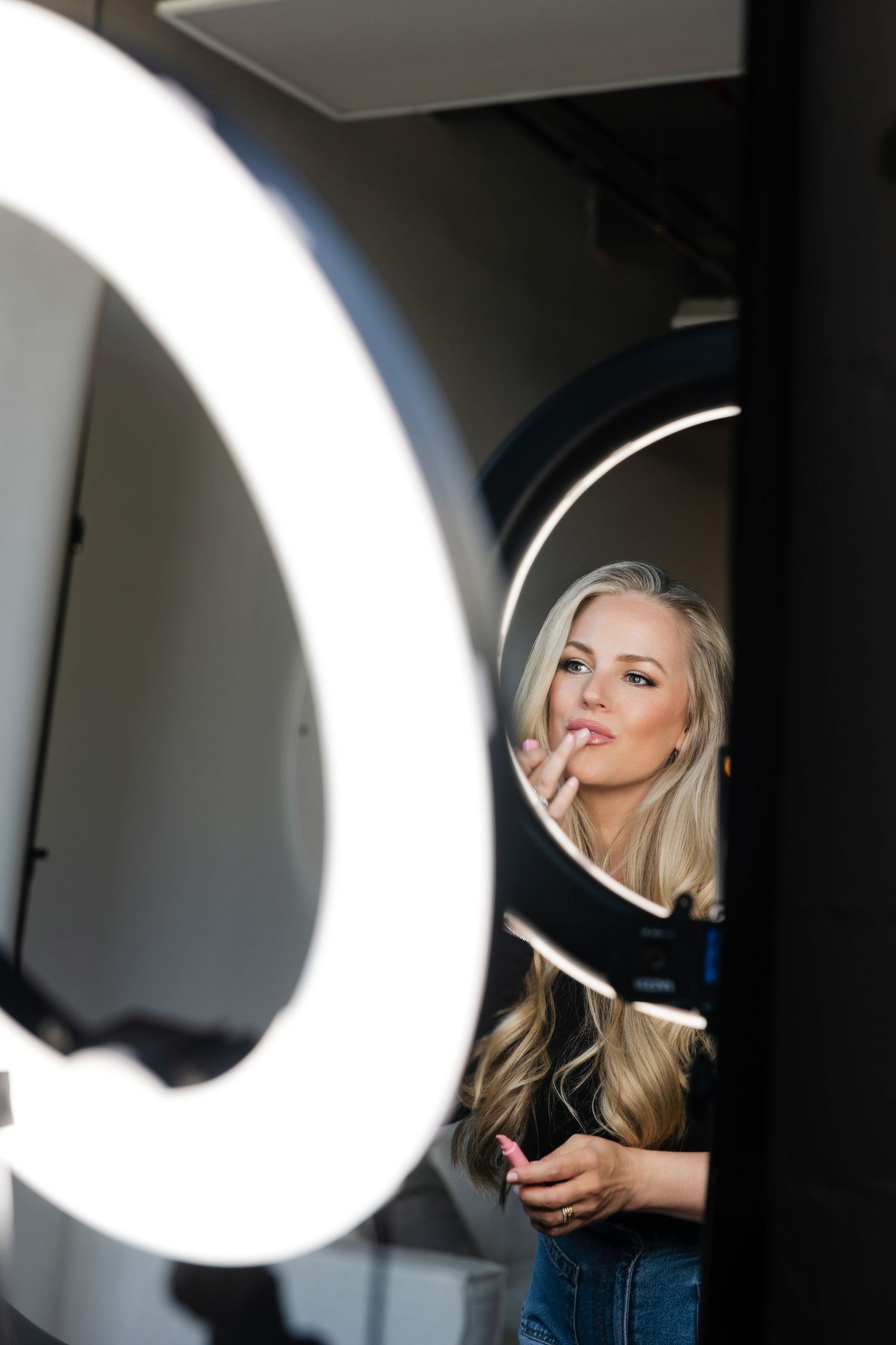 Behind the scenes photo shoot with ring light and camera equipment.
