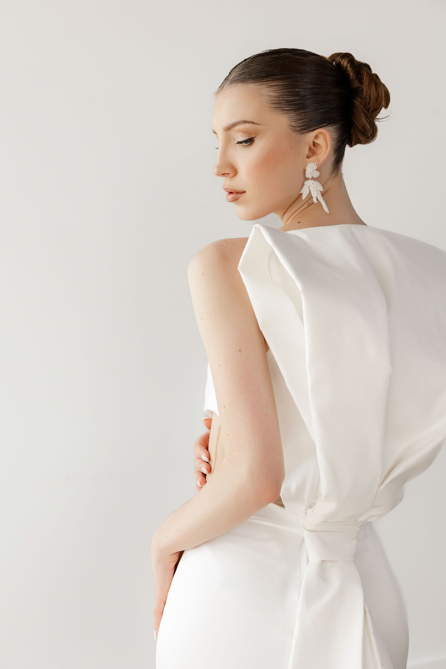 Structured white bridal top with architectural details shown from various back angles.