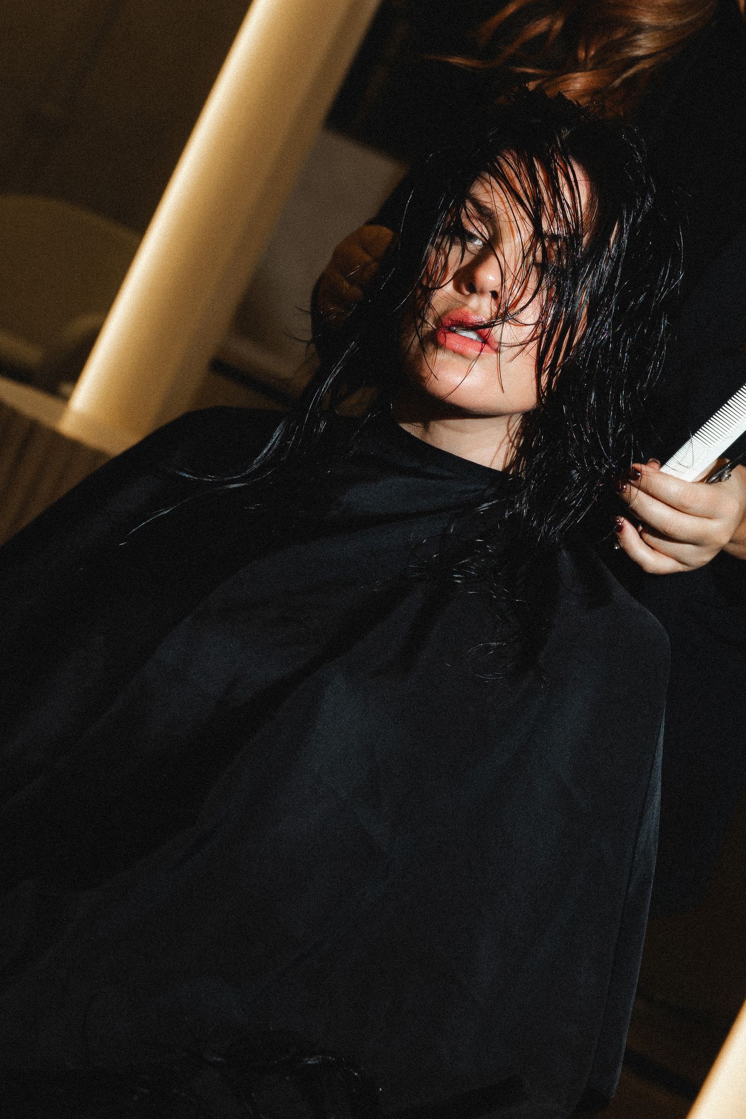 Professional hair styling session showing wet hair being worked on.