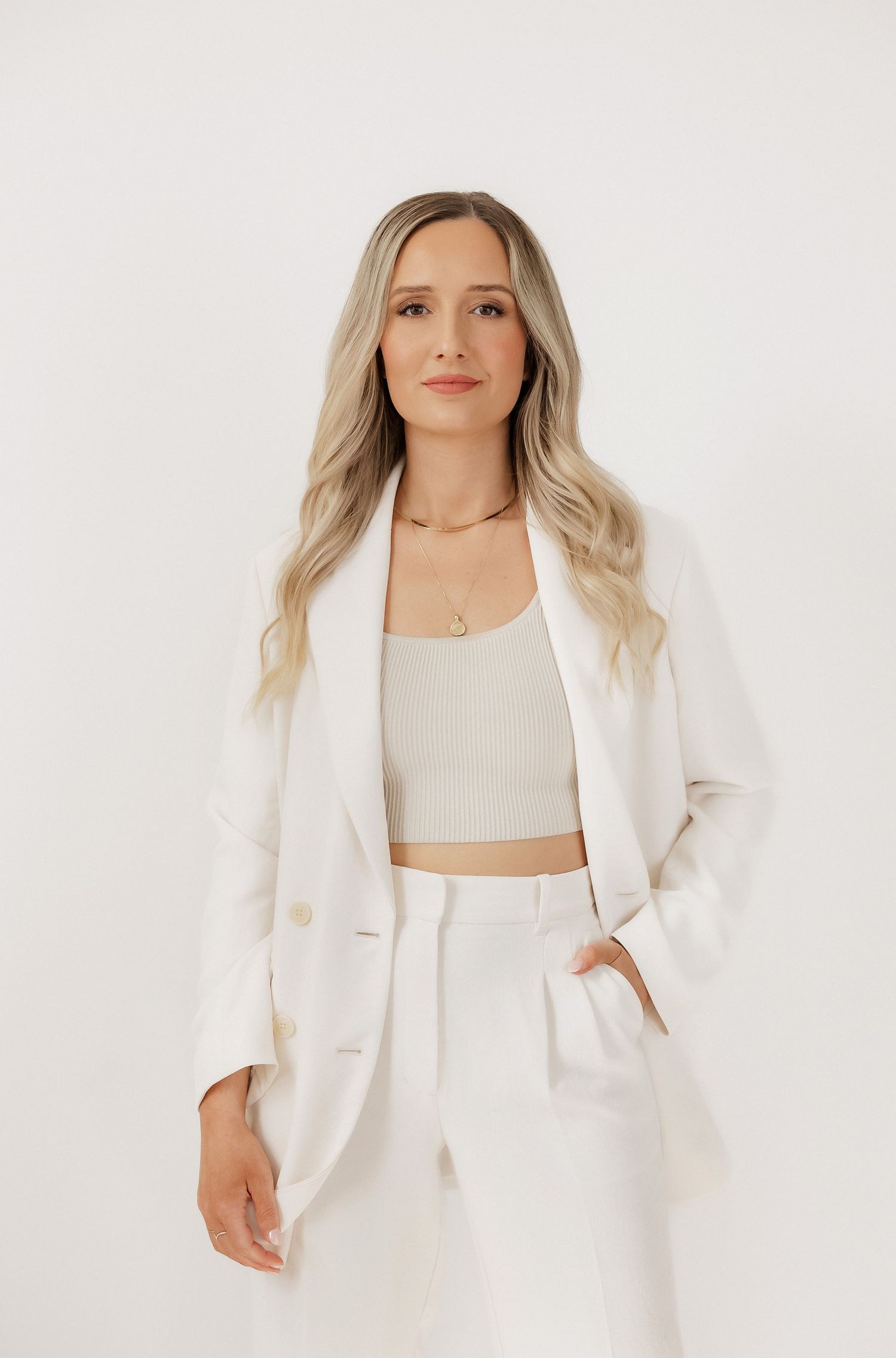 Lifestyle fashion photography featuring white monochromatic outfit.