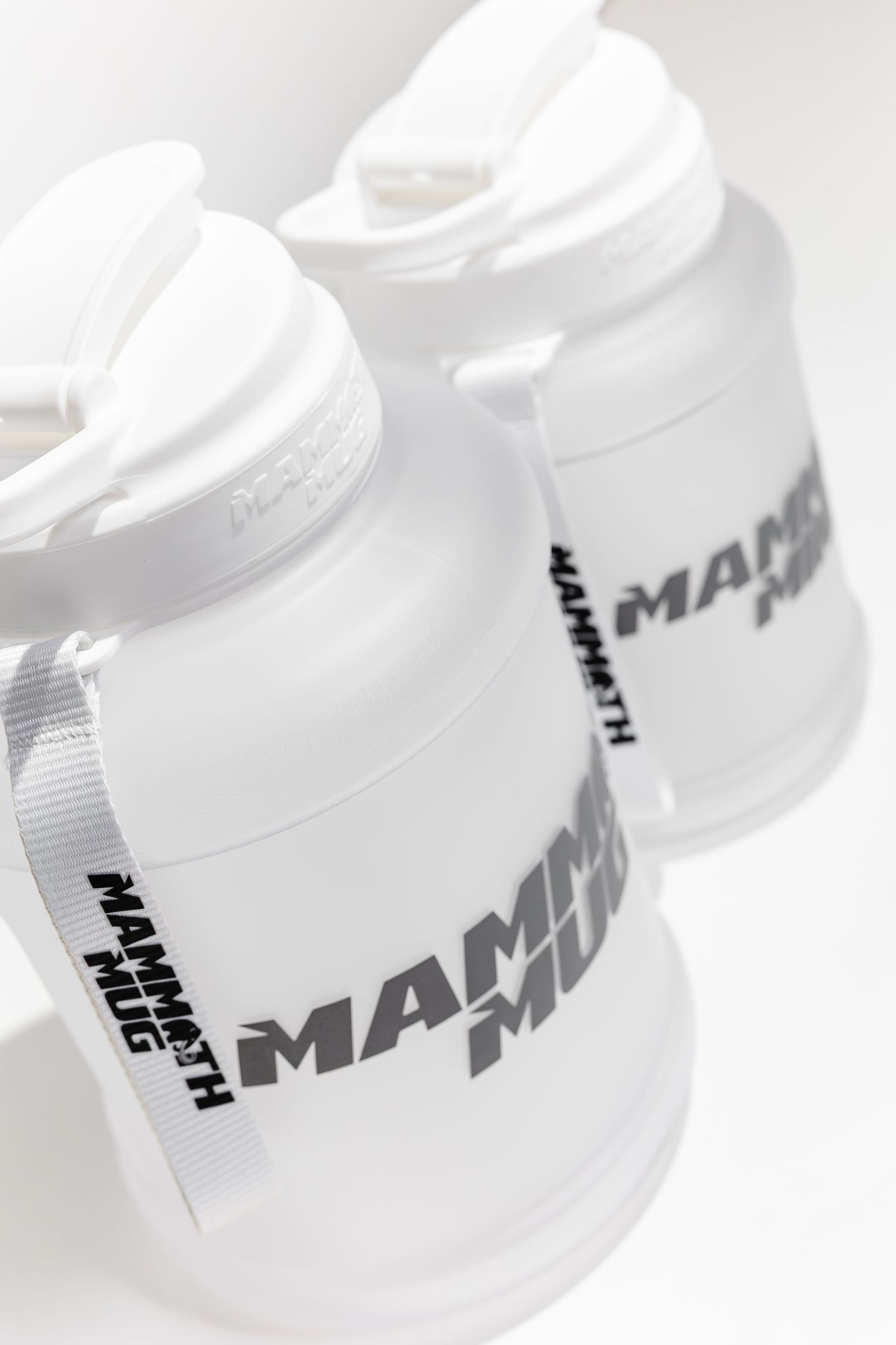 Close-up view of white plastic drink containers with Mammoth Mini branding.