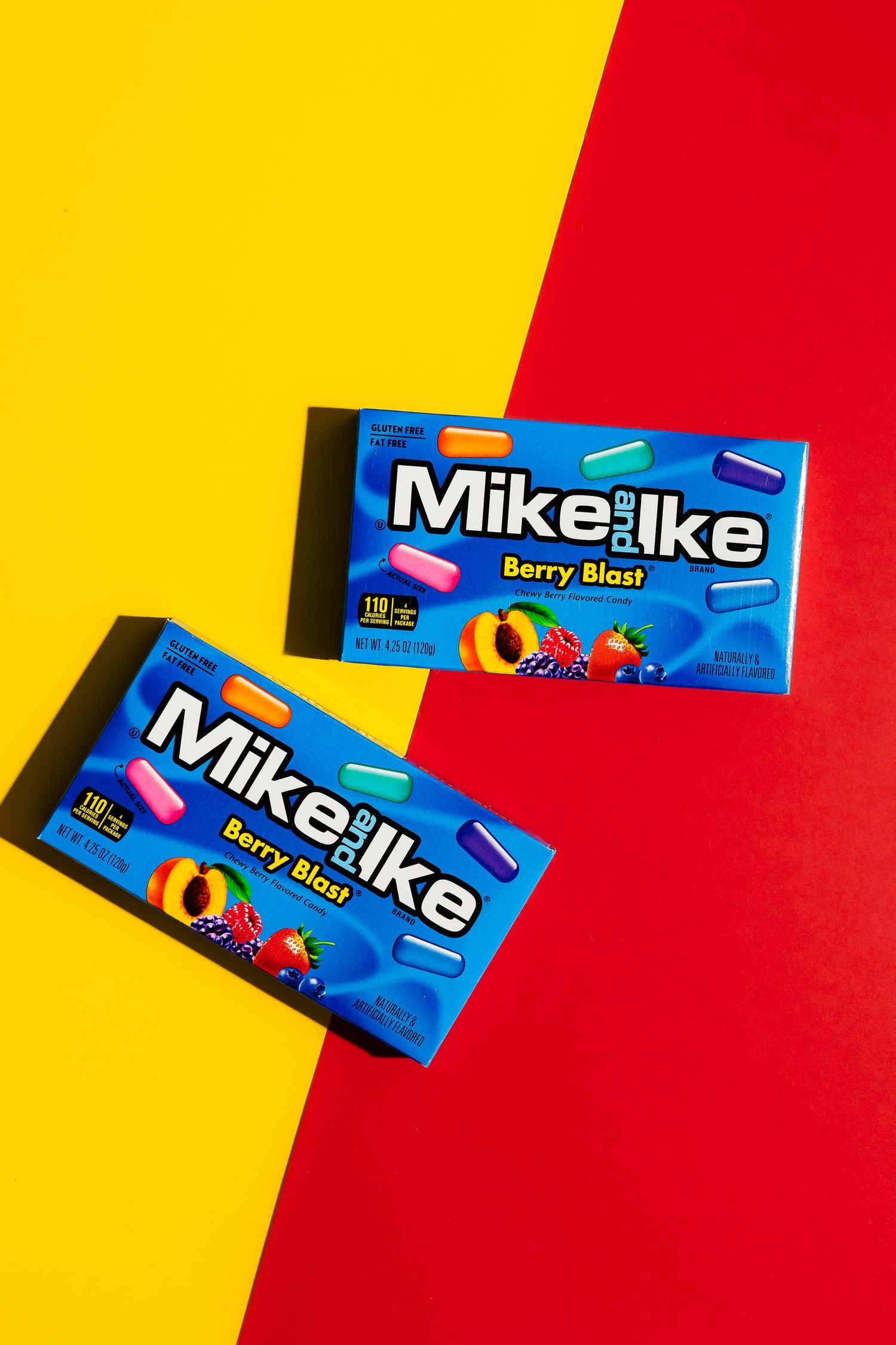 Mike and Ike Berry Blast candy boxes displayed on red and yellow background.