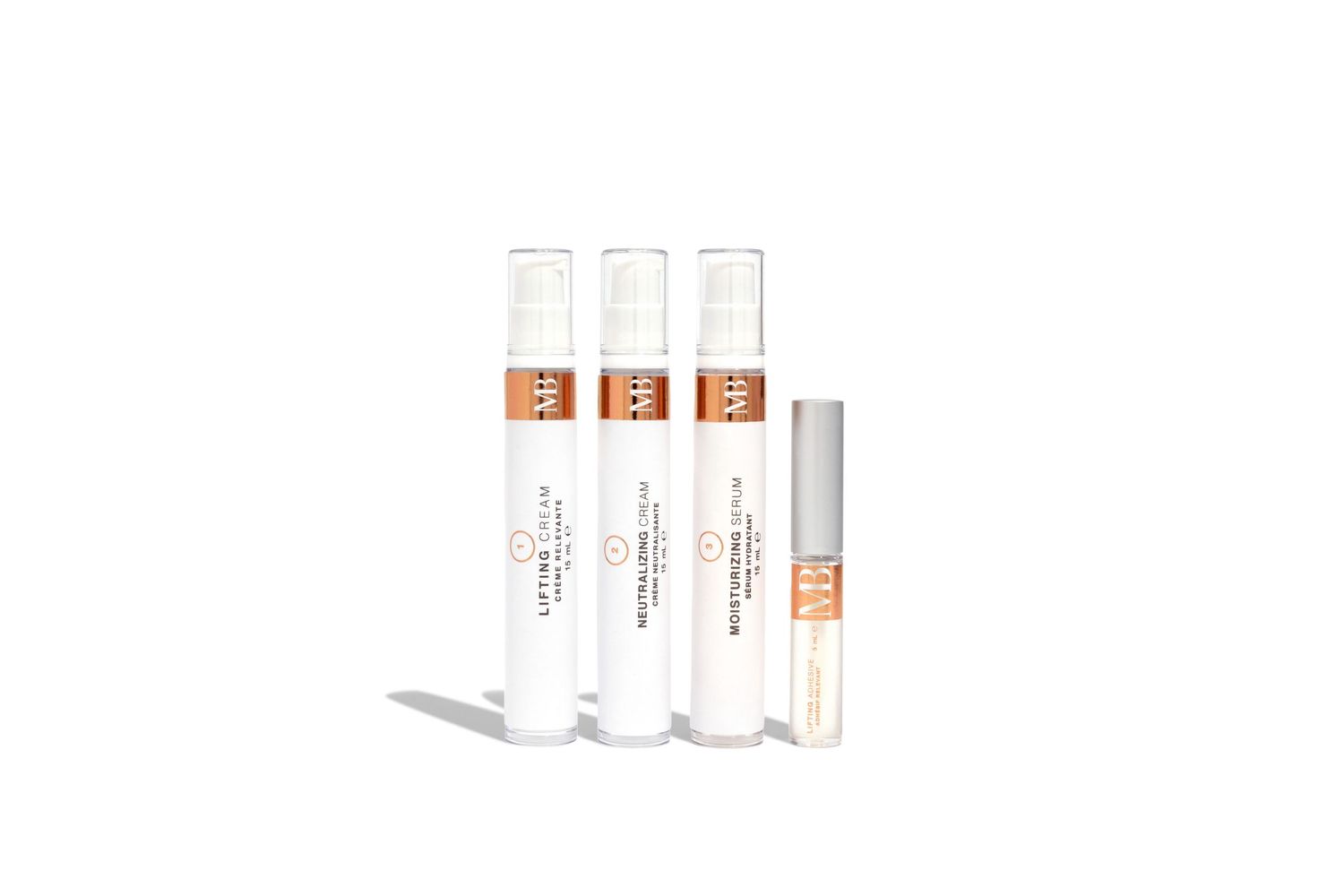 Set of white cosmetic tubes with copper accents arranged on white background.