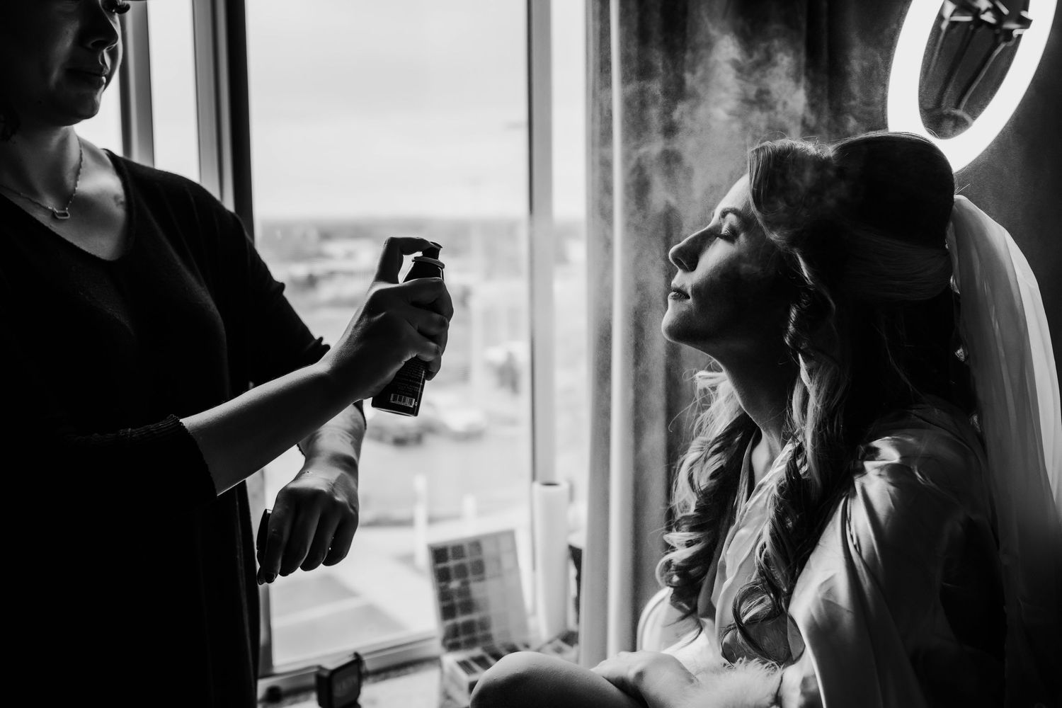 Detail shot of a bride getting her makeup done by a makeup artist
