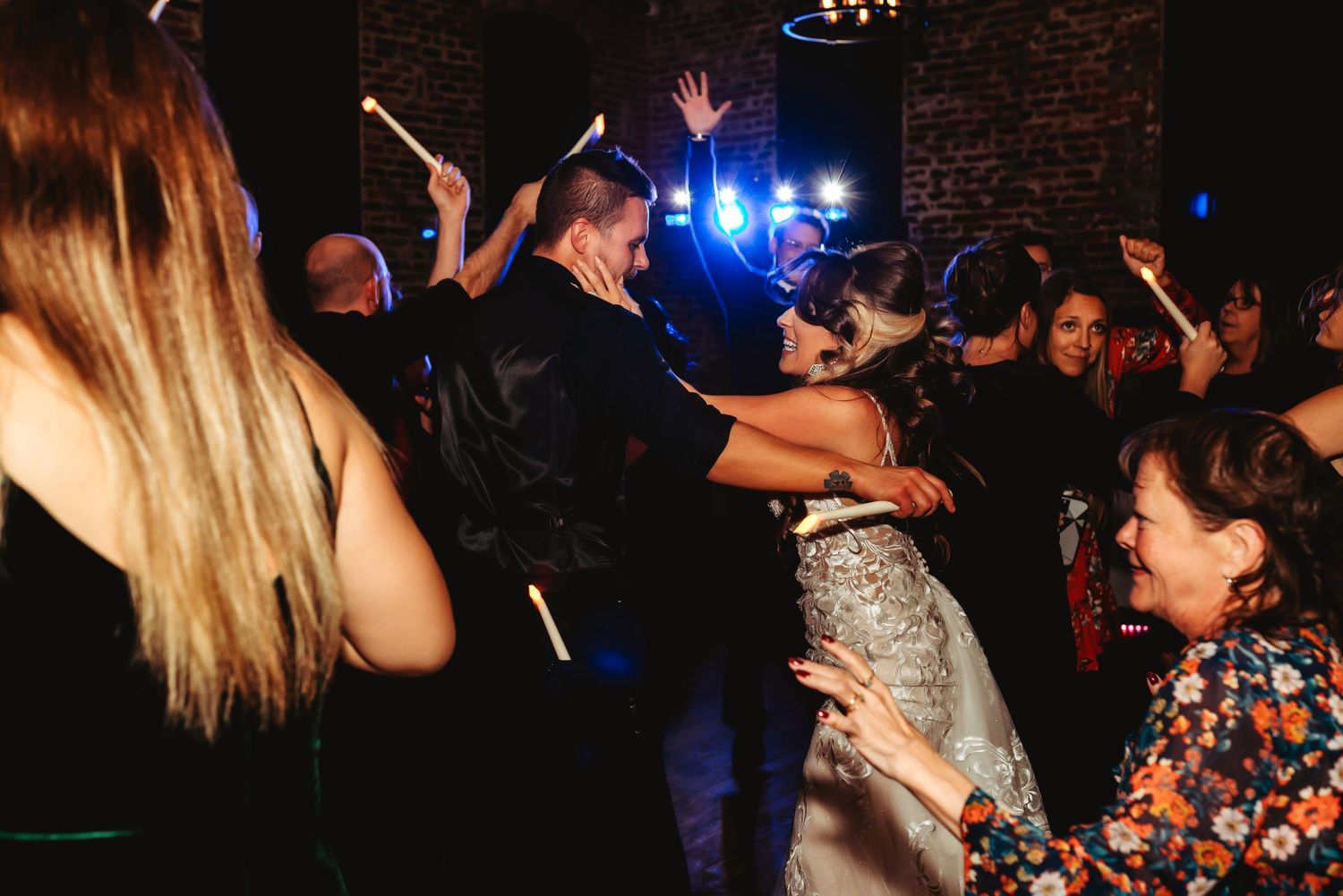A candid shot of the bride and groom dancing at their wedding reception.