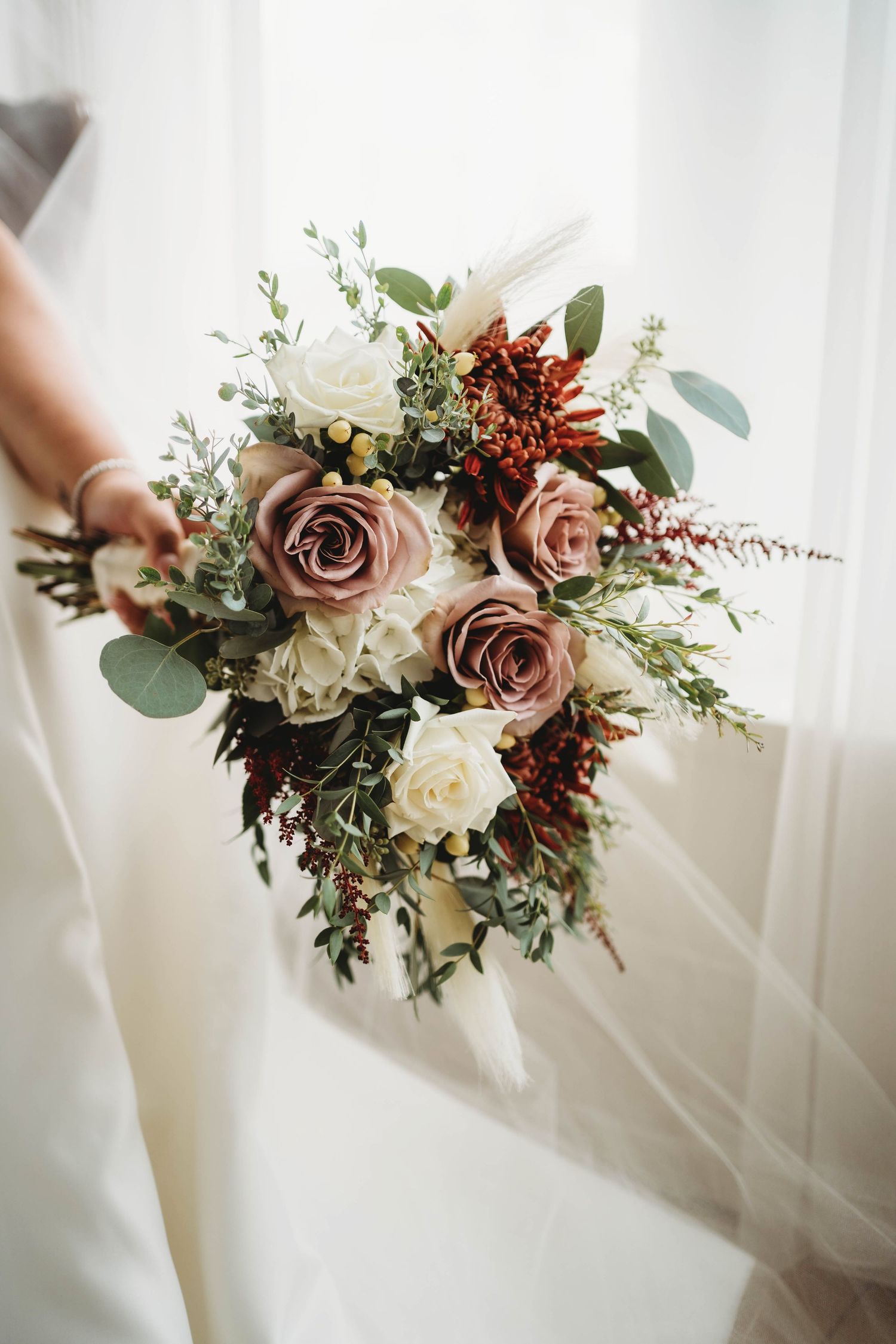Beautiful bridal bouquet featuring dusty rose and white flowers with eucalyptus greenery. Popular in Tennessee