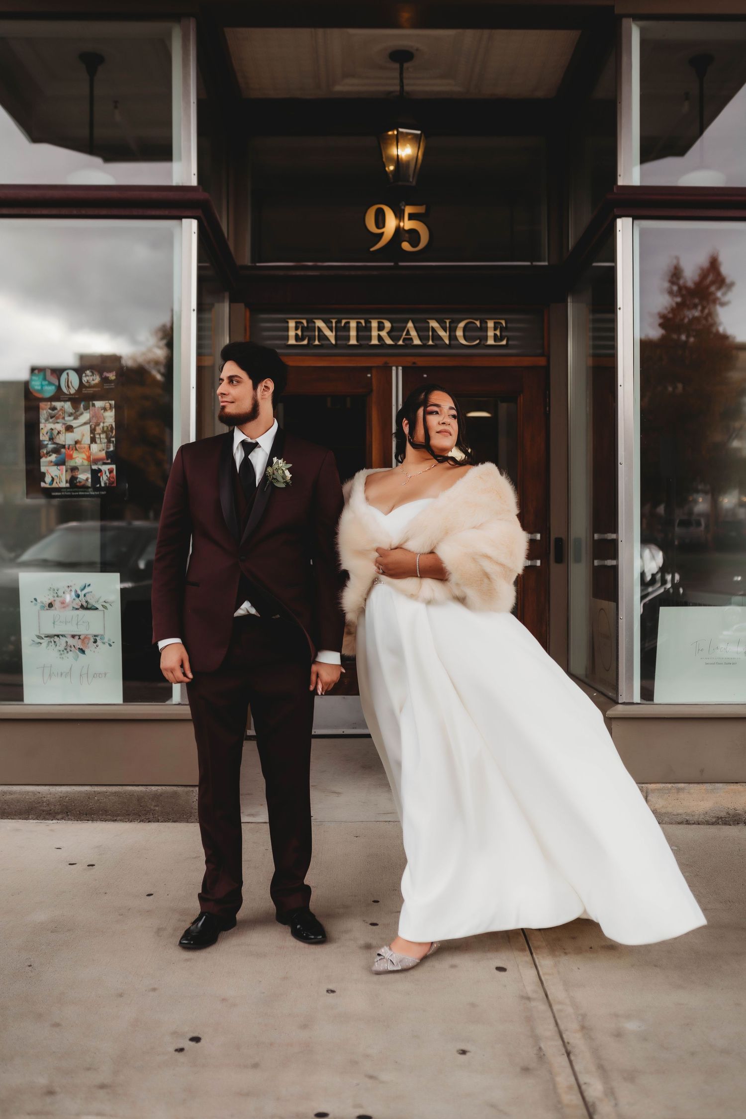 Playful wedding photoshoot sequence showing couple posing outside a storefront entrance.