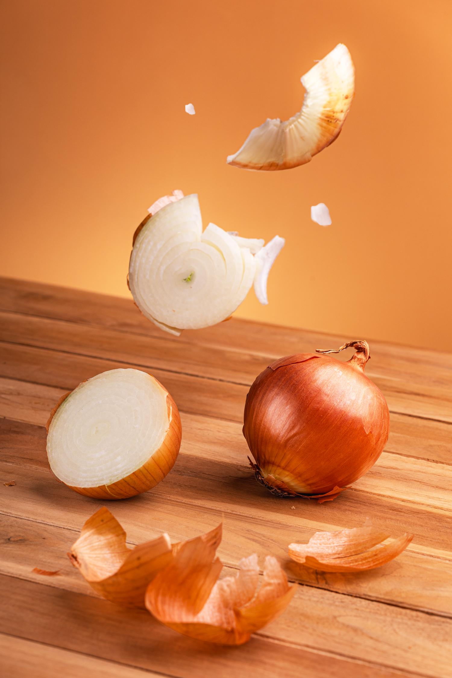 Editorial food photography featuring floating onions captured with dynamic lighting and motion effects.