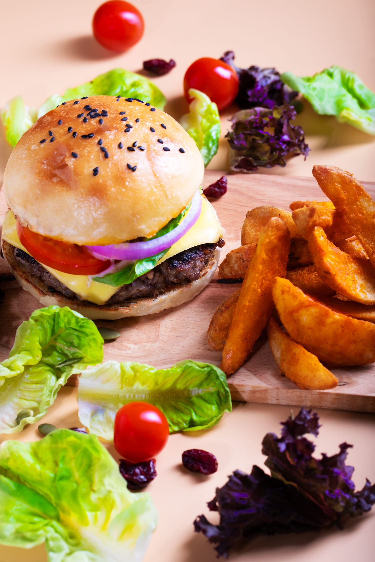 Professional burger photography featuring a gourmet burger, potato wedges, and fresh salad styled for café marketing.