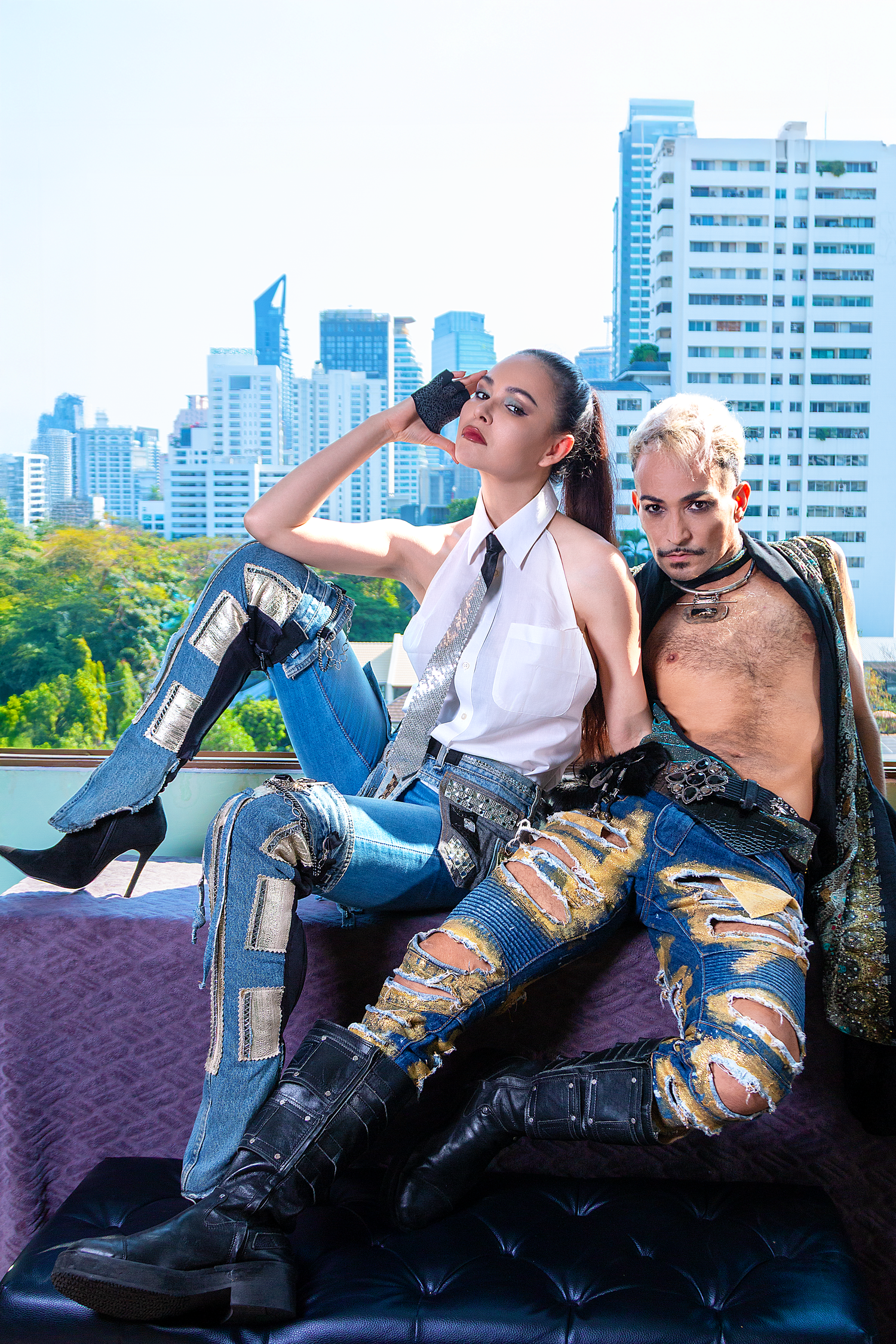 Creative lifestyle photography featuring two fashion models posed in an outdoor city environment in Bangkok.