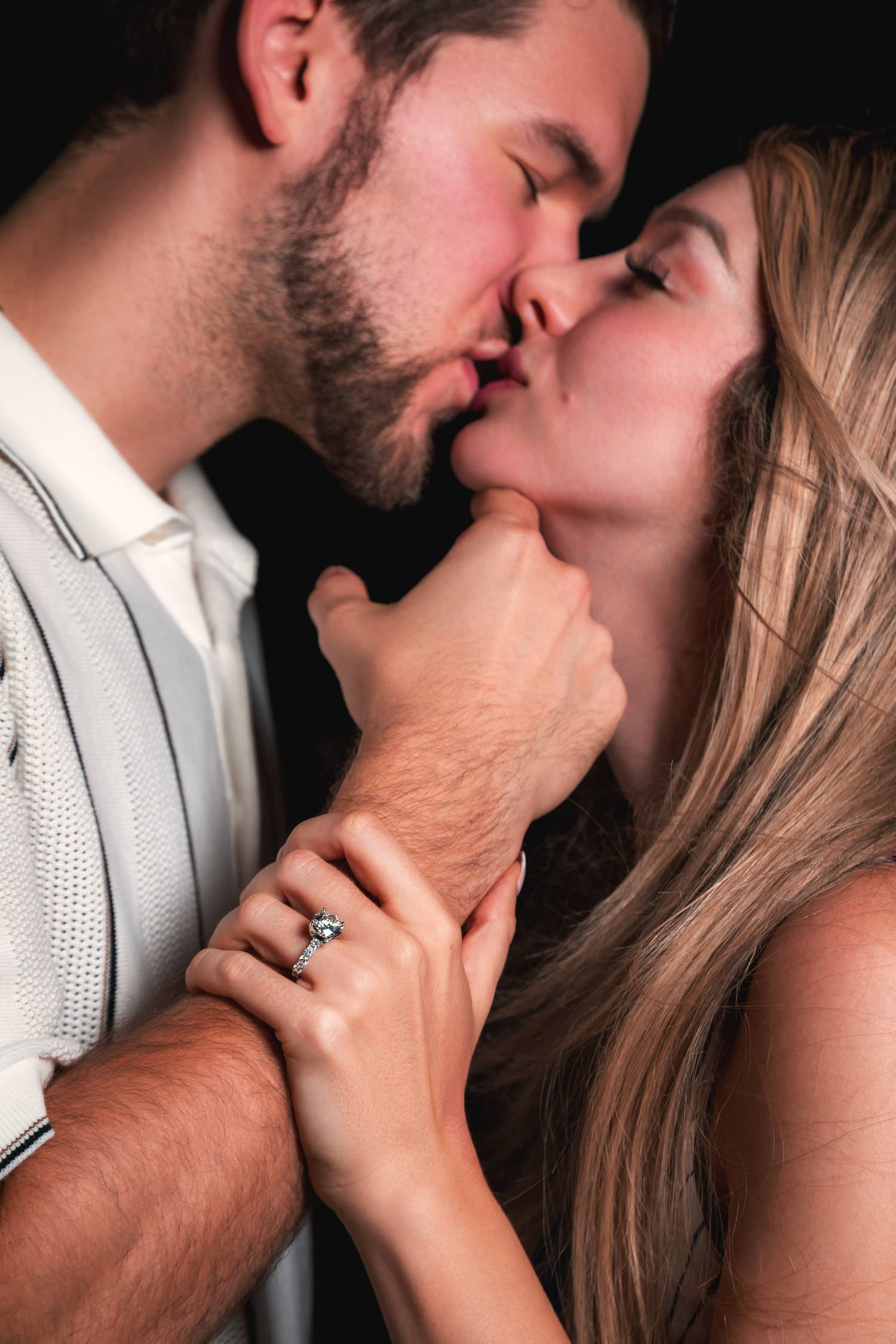 Intimate lifestyle portrait of a couple sharing a close moment during a professional photoshoot.